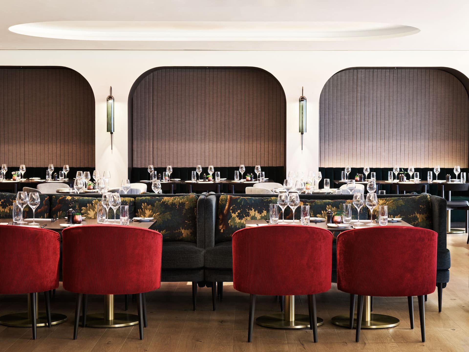 Elegant dining featuring the marble tables, the red seats at the restaurant in Stratford London