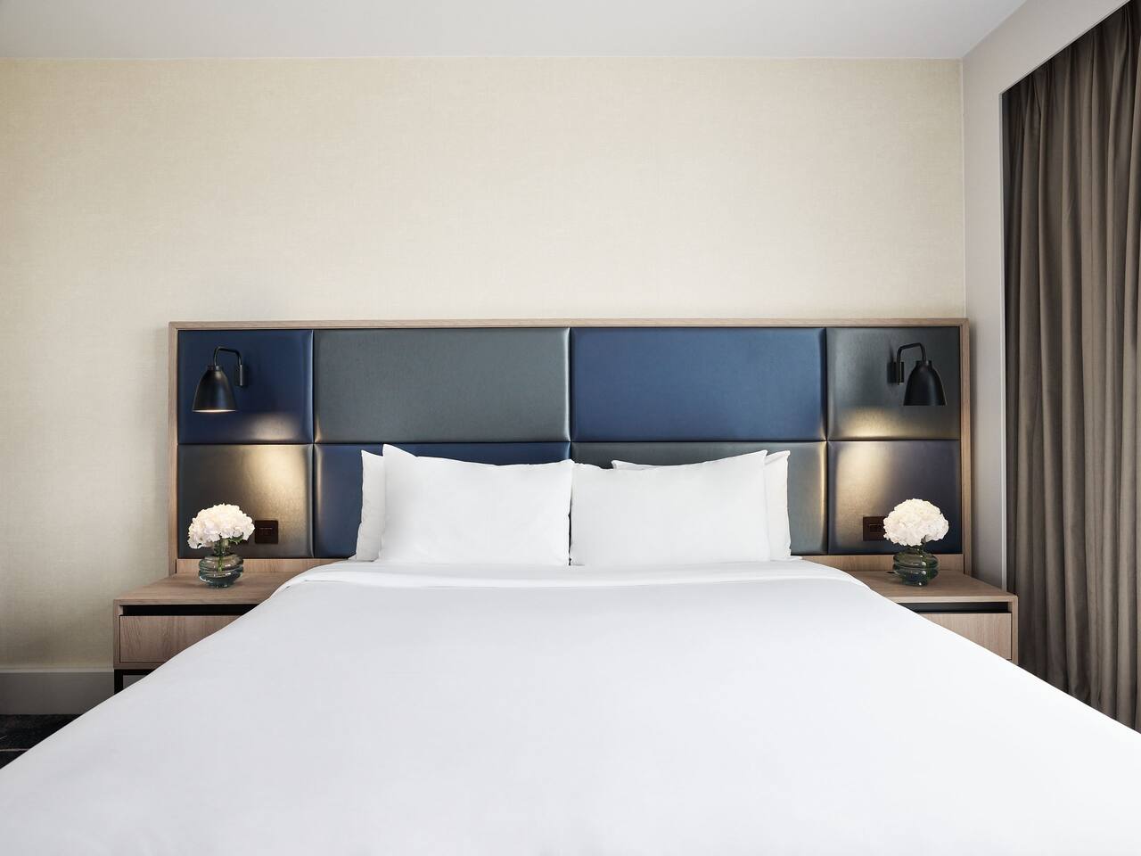 Bedroom at Hyatt Regency Manchester with lamps on 