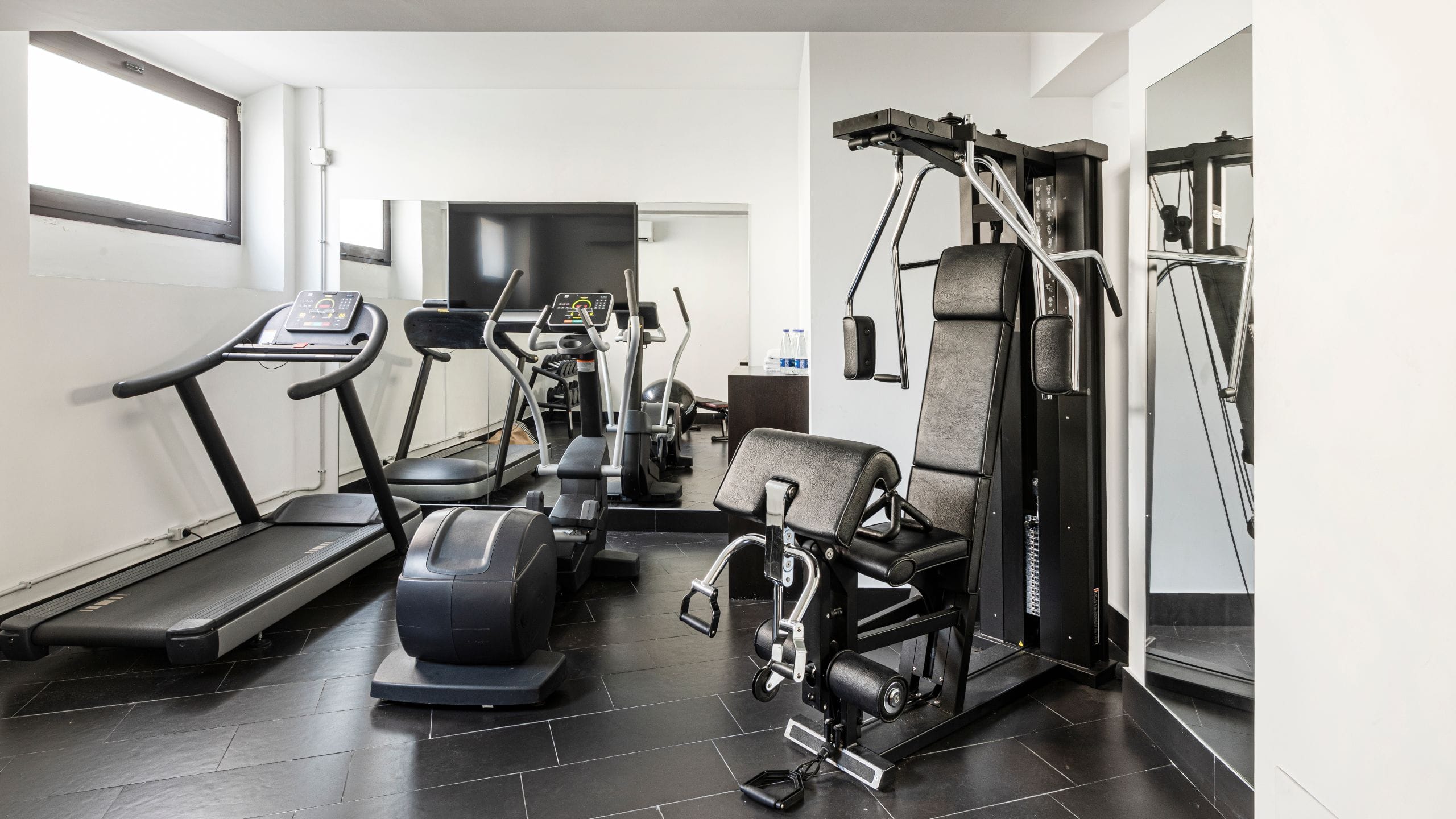 Fitness center with modern equipment at The Tribune Hotel Rome