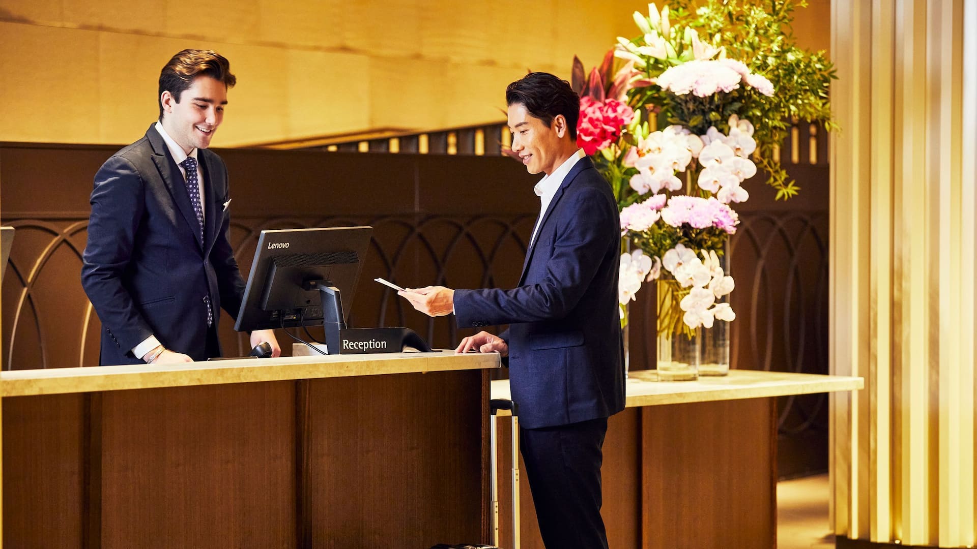 Global Man Checking In Front Desk