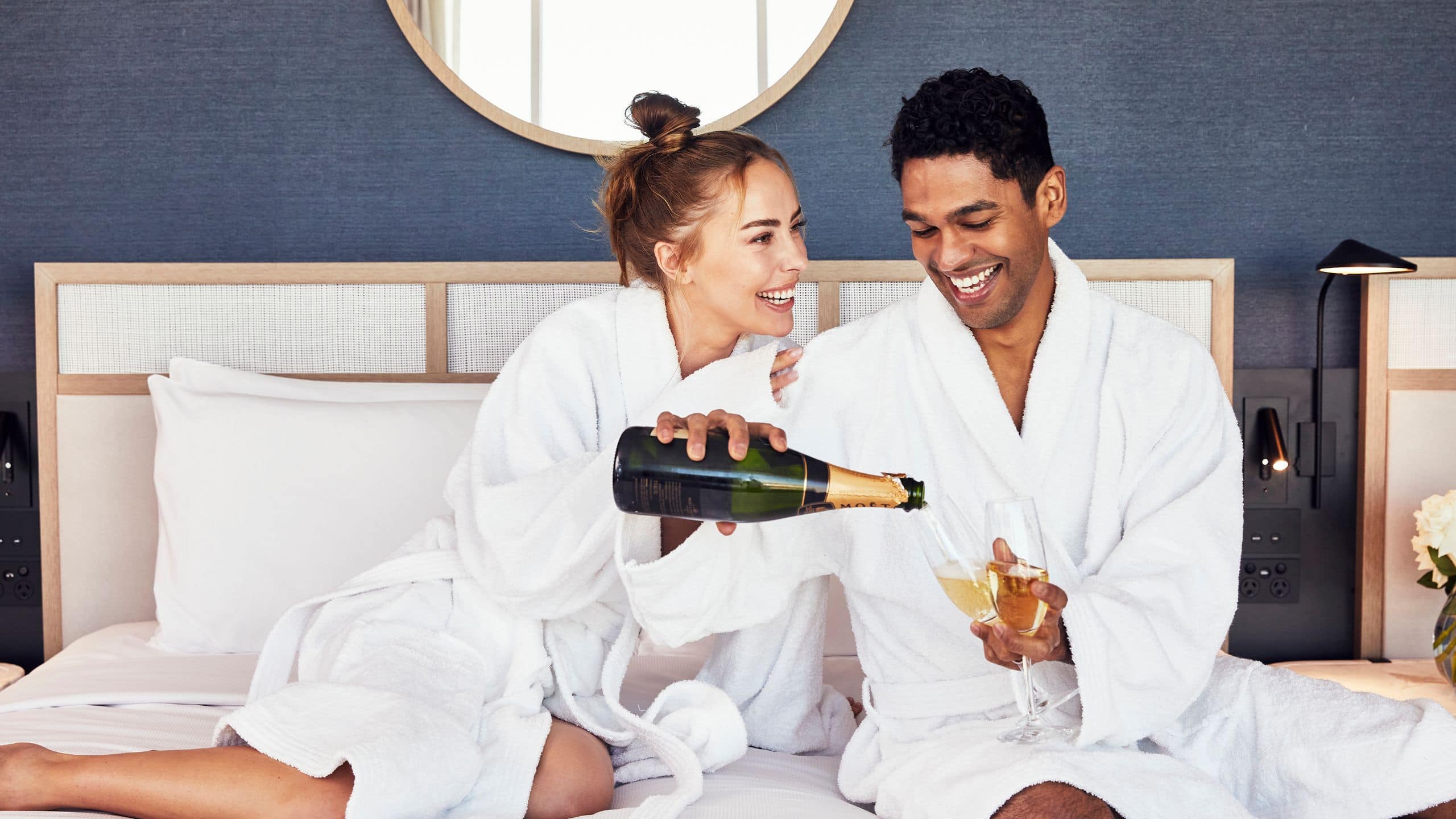 Global Couple Bed Pouring Champagne