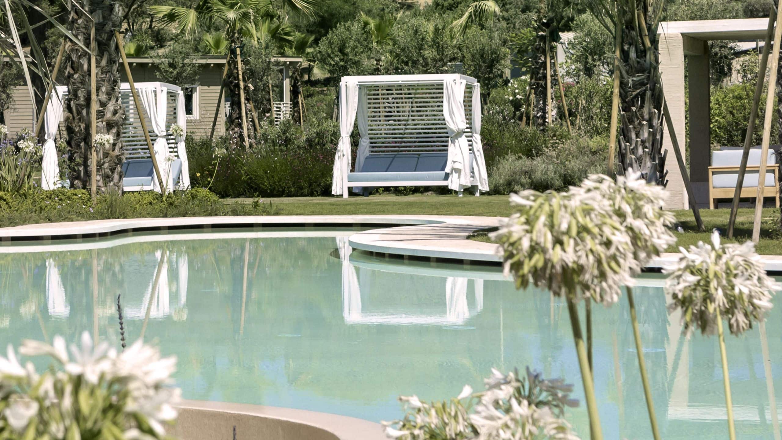 7Pines Resort Sardinia Laguna Pool Daytime Sunbeds View
