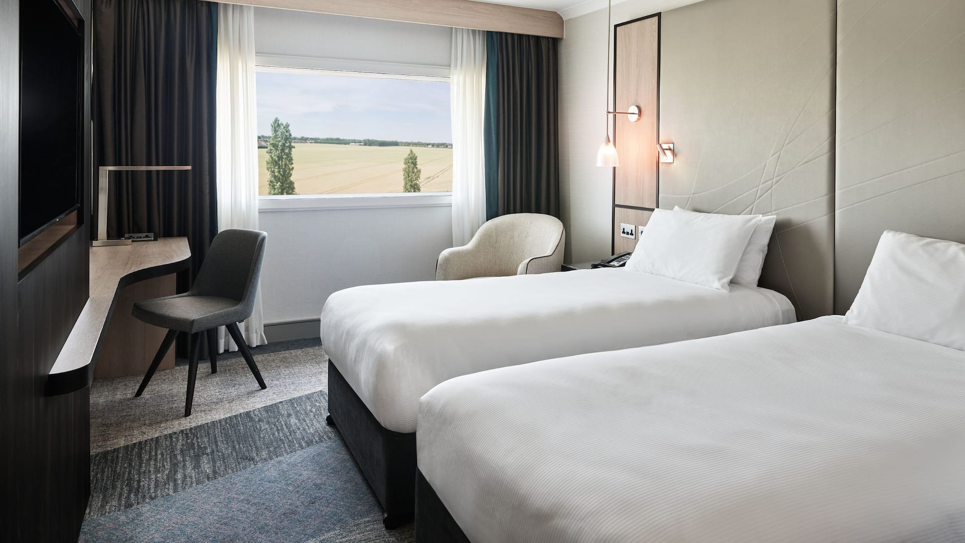 Room with two twin beds, modern decor, large window, high-floor view at hotel and parking Heathrow