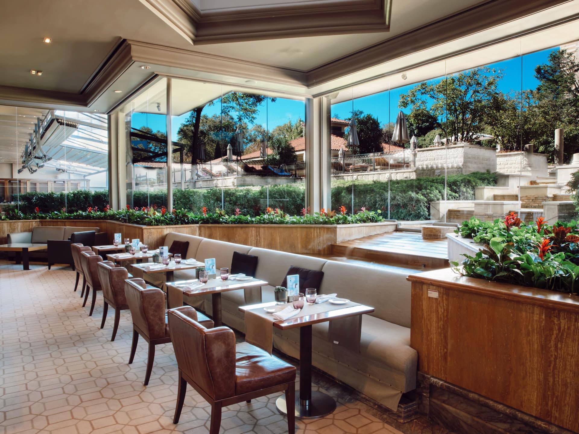 Mezzanine Lounge at Grand Hyatt Istanbul with elegant afternoon tea setup: salmon sandwiches, tartes, macarons, and tea on white tablecloth.