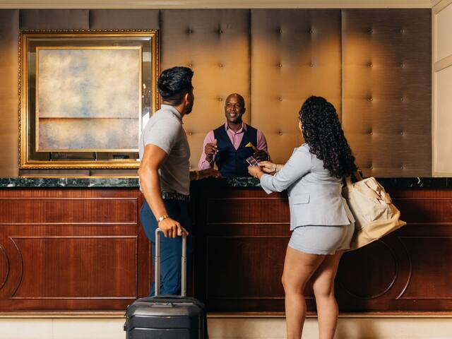 Couple Checking Into Hotel