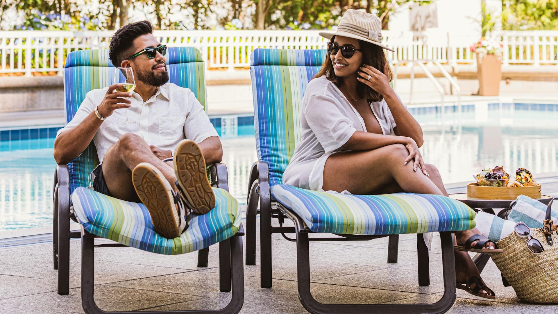 Grand Hyatt Atlanta in Buckhead Couple Sitting By Pool On Chaises