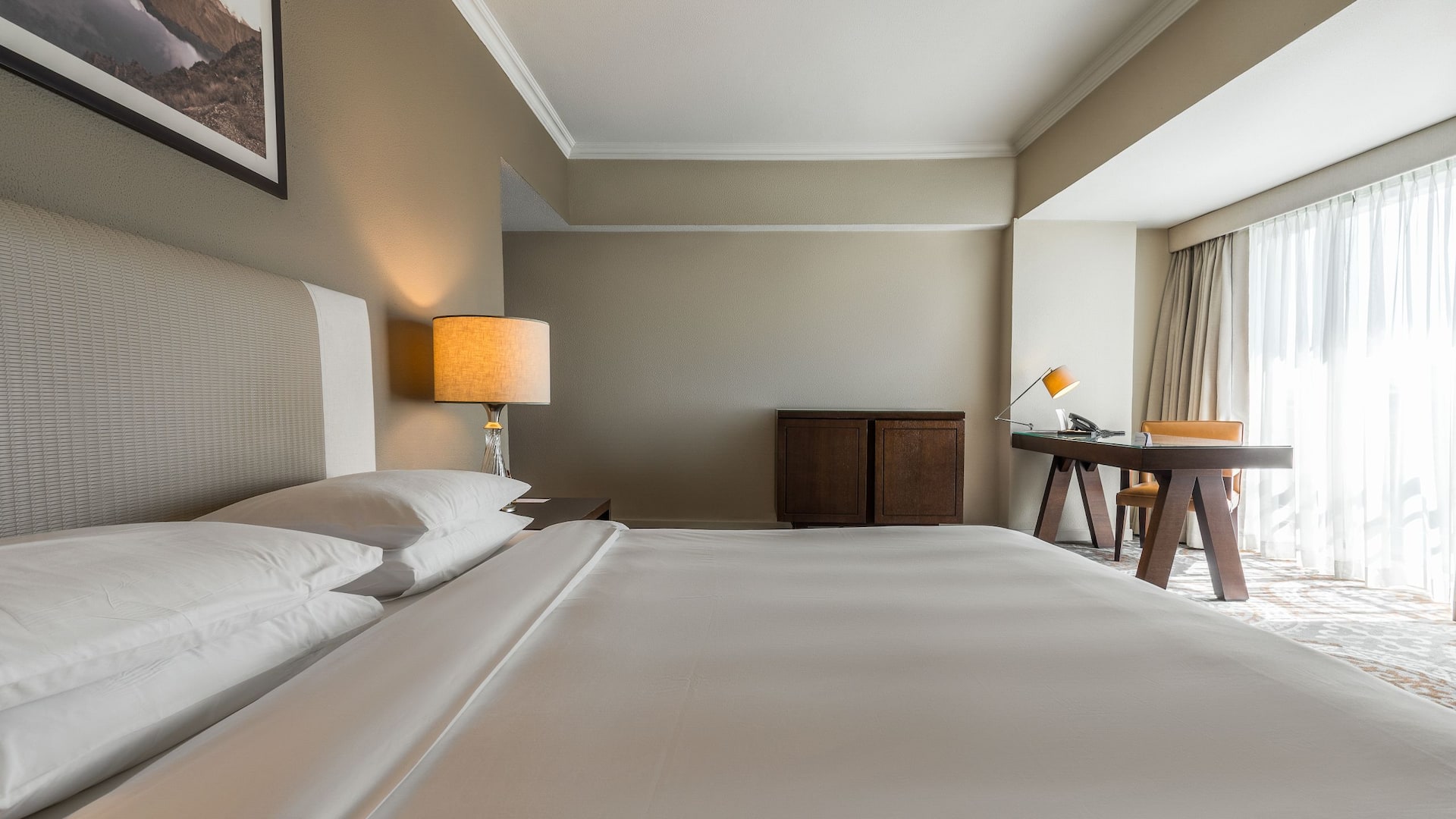 Hotel Room Featuring a King Bed and a Functional Work Desk