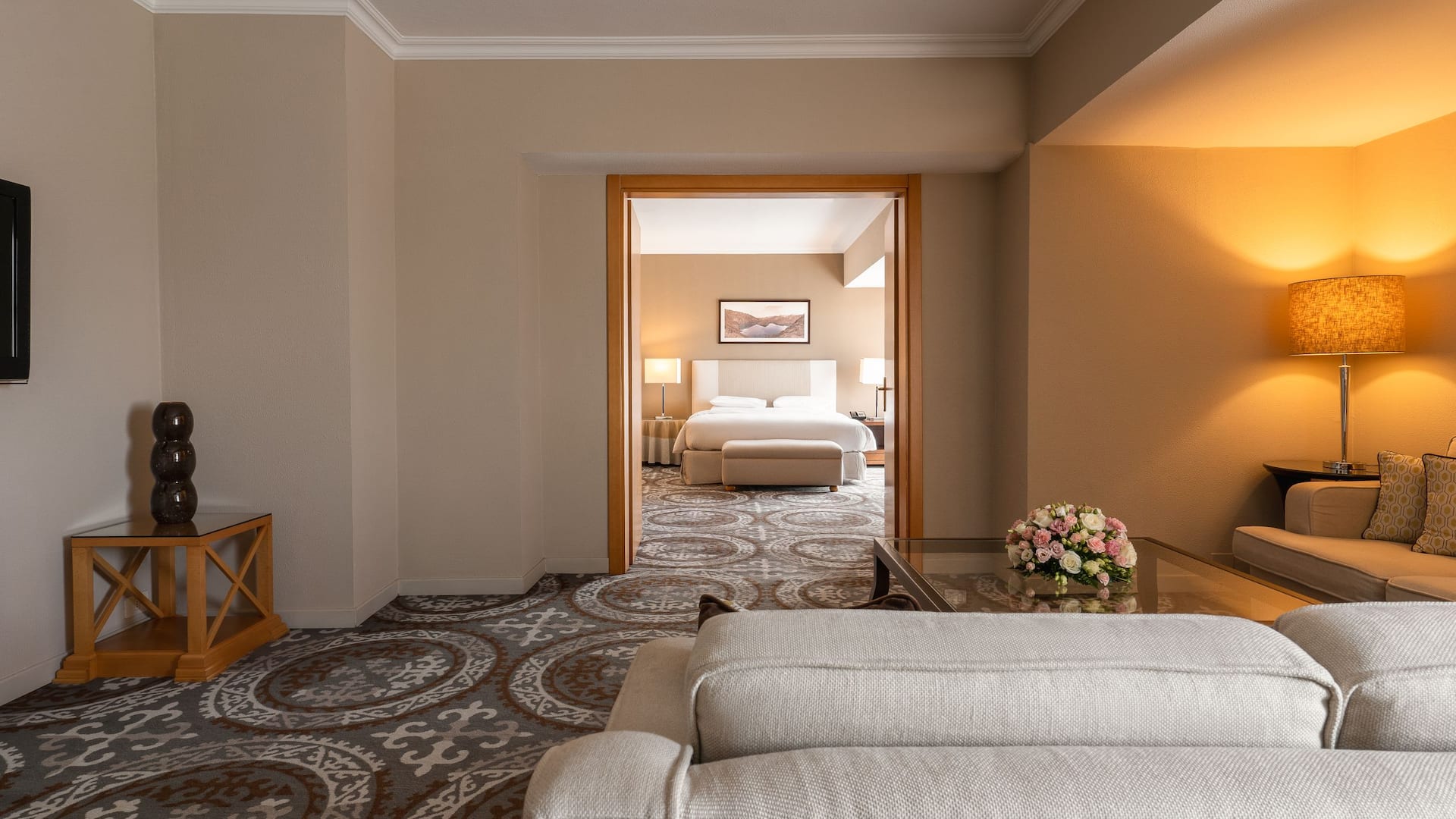 Elegant suite featuring king bed, living room, dining area, kitchenette, workspace, luxury bath, and mountain views