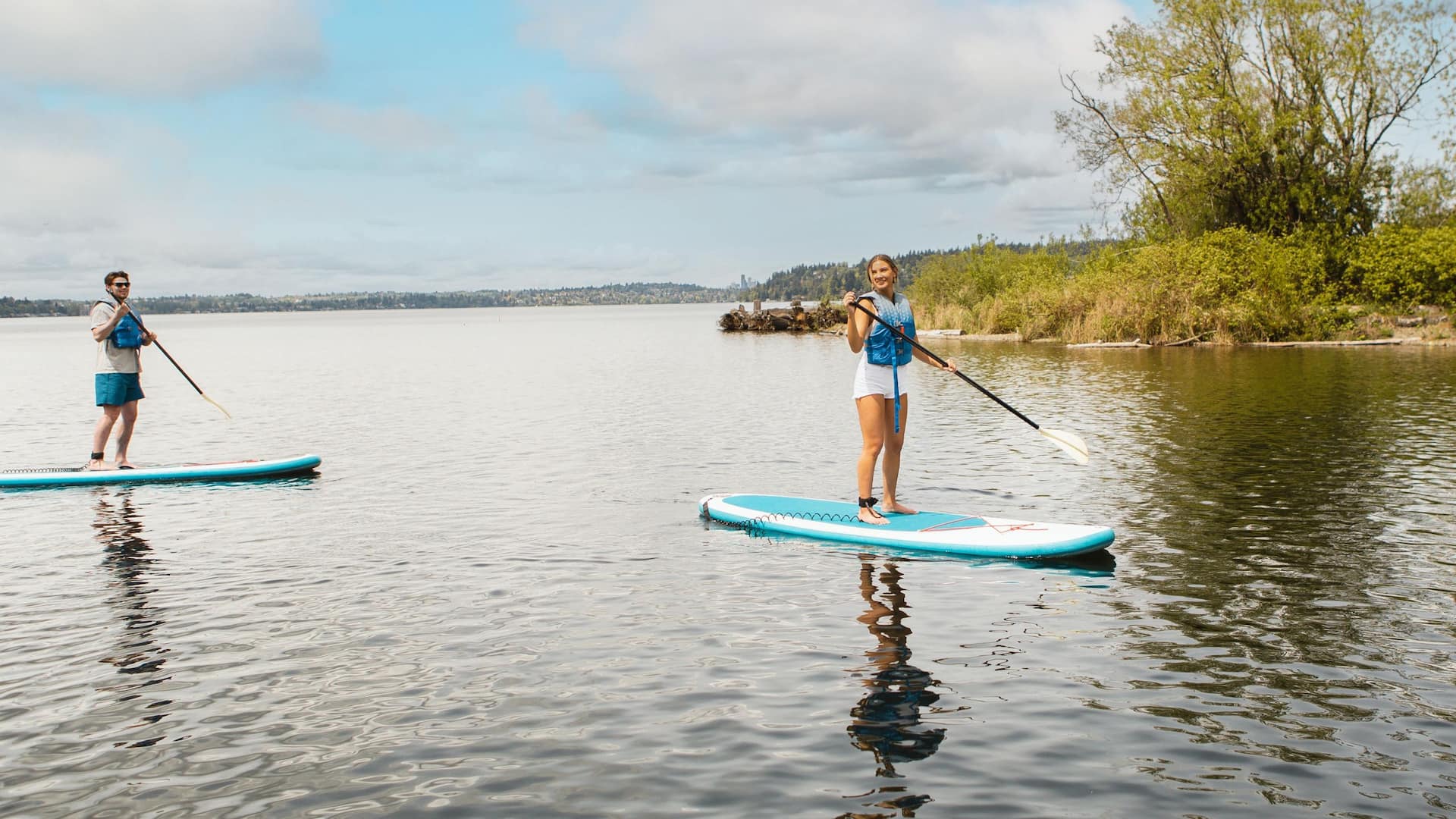 Hyatt Regency Lake Washington at Seattle's Southport Couple Paddle Boarding