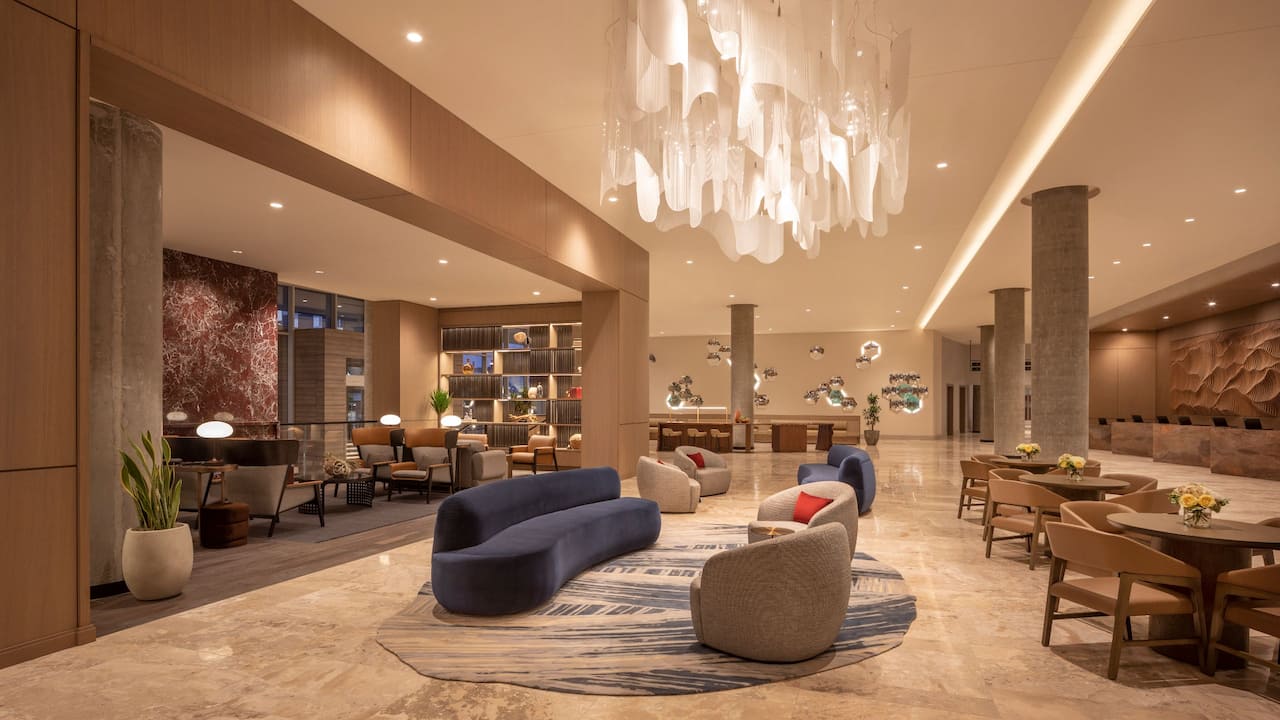 Luxurious lobby design featuring a stylish chandelier and comfortable seating