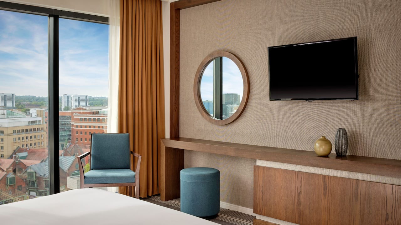 Workspace with armchair and a glimpse of hotel bedroom