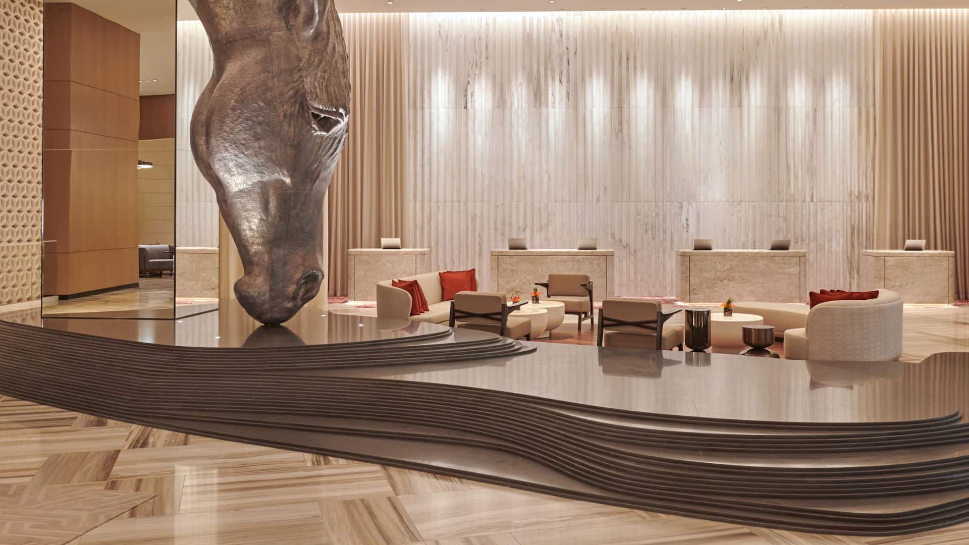 Spacious hotel lobby of Grand Hyatt Kuwait decorated with dramatic original works of art