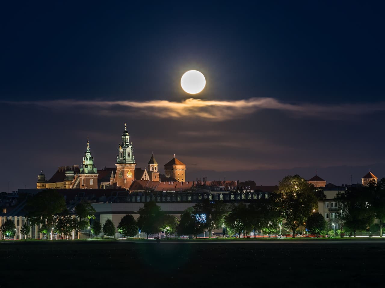 Wawel Castle and moon as seen from Blonia meadow
