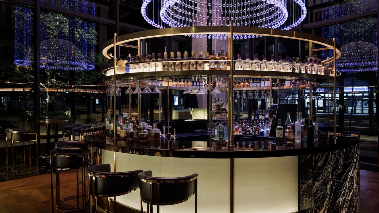 The round shaped bar counter of The Union Bar & Lounge with a crystal chandelier.