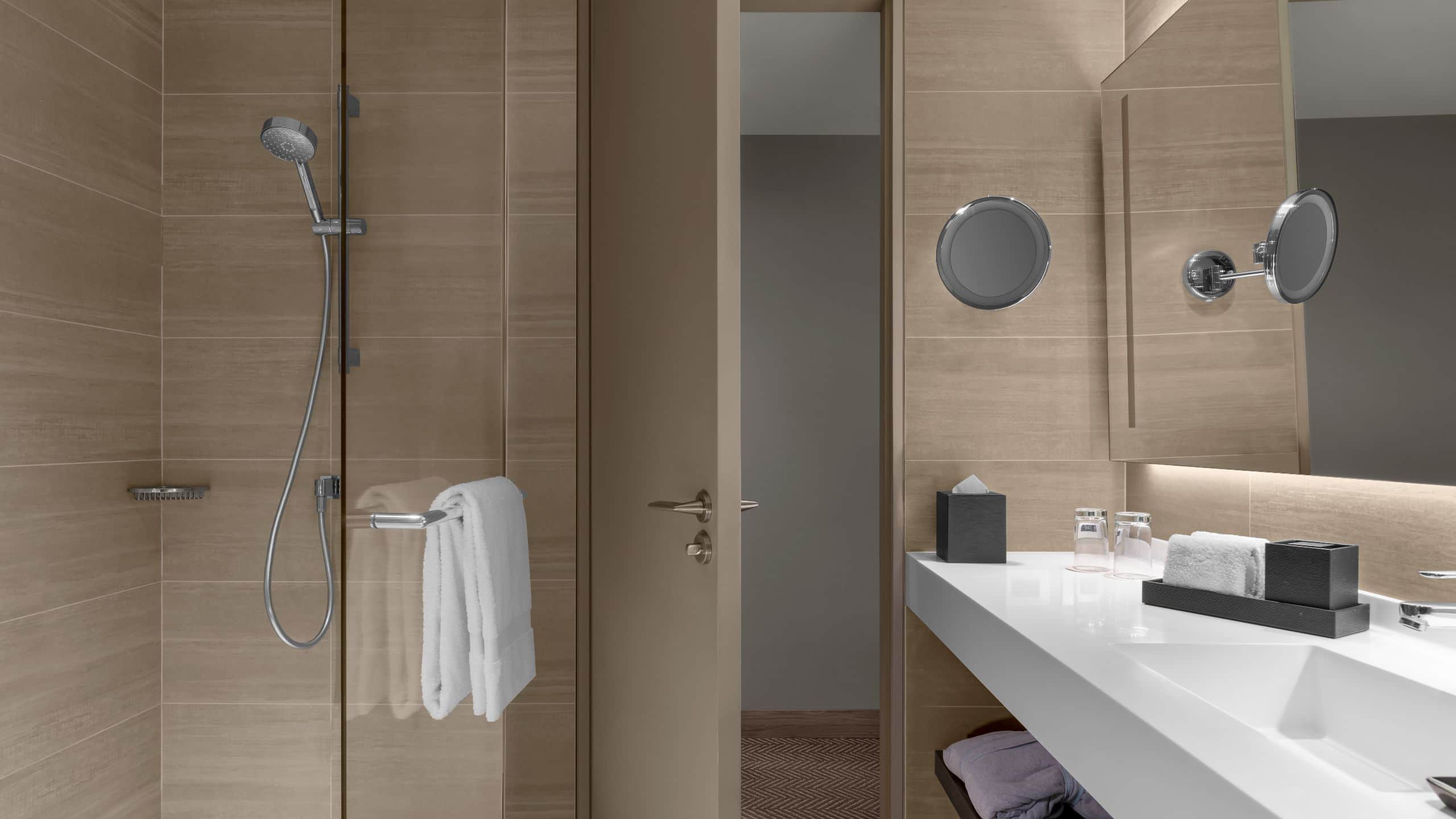 Guest room bathroom with large vanity and walk in shower