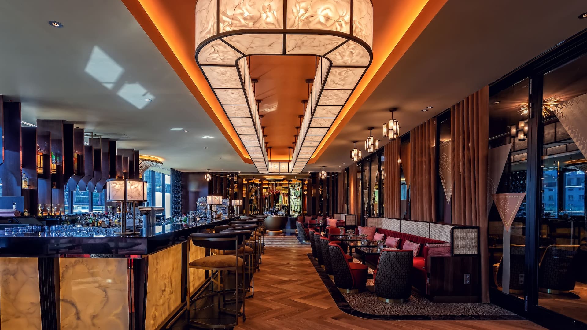 DOX Bar, Hyatt Regency Dusseldorf golden counter, bar stools, champagne lounge, and rich brown red gold tones
