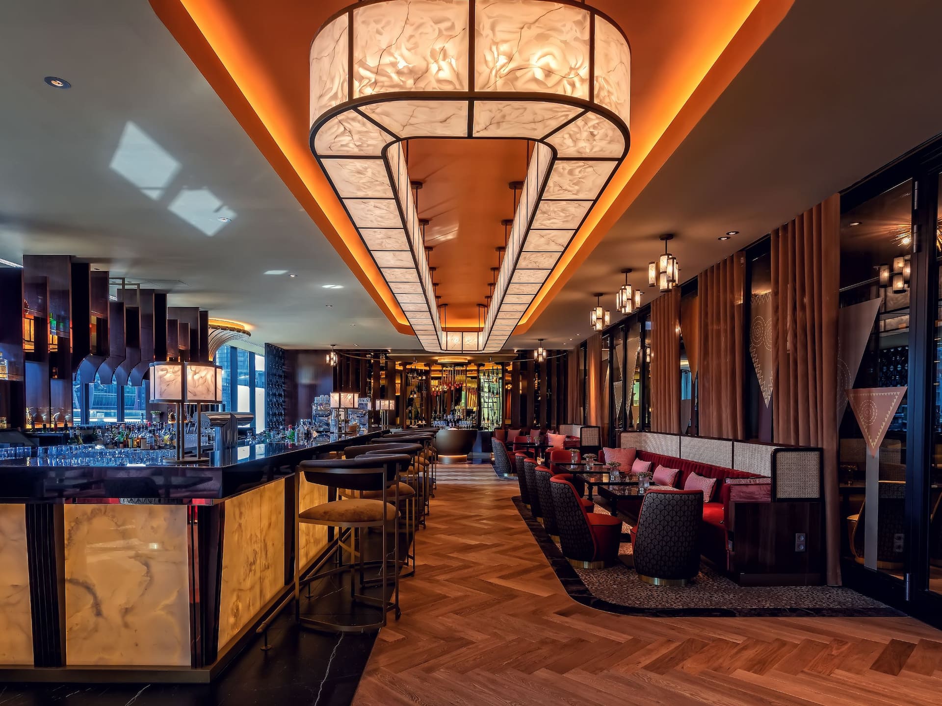 DOX Bar, Hyatt Regency Dusseldorf golden counter, bar stools, champagne lounge, and rich brown red gold tones