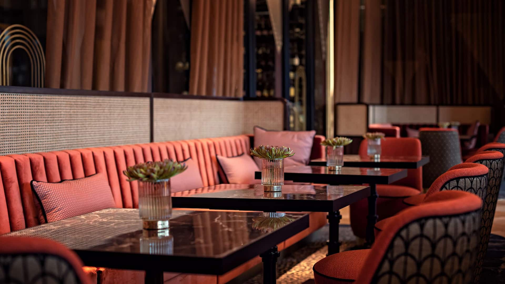 DOX Bar at Hyatt Regency Dusseldorf, bar with many seating options on armchairs and couch in brown red style and marble table