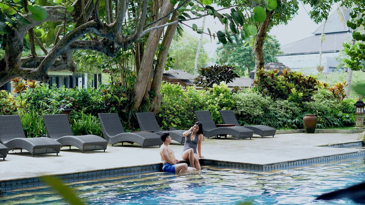 Couple sitting on the poolside