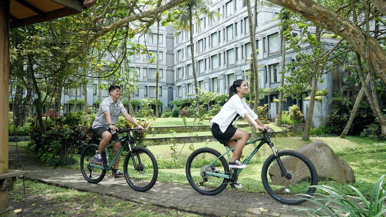 Couple Cycling Around The Resort