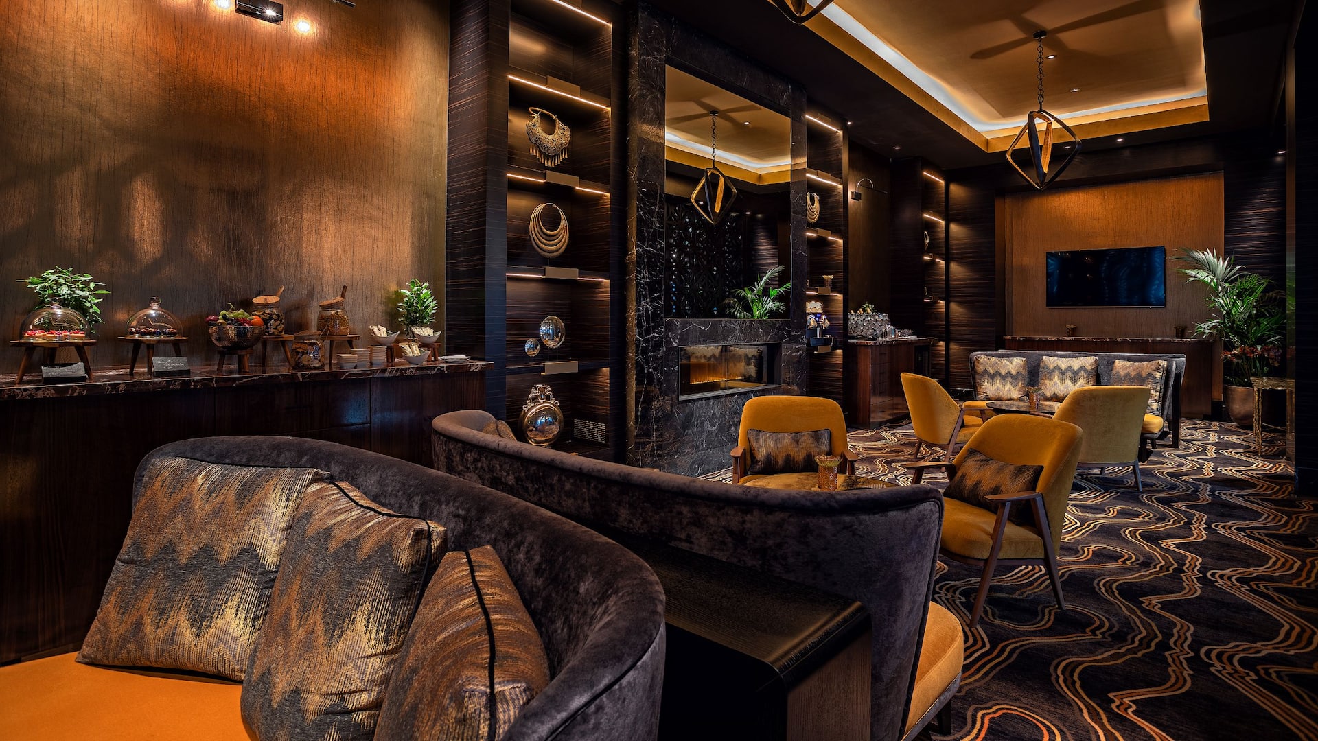 Regency Club Lounge at Hyatt Regency Dusseldorf, with comfortable couches, armchairs, fireplace and food station