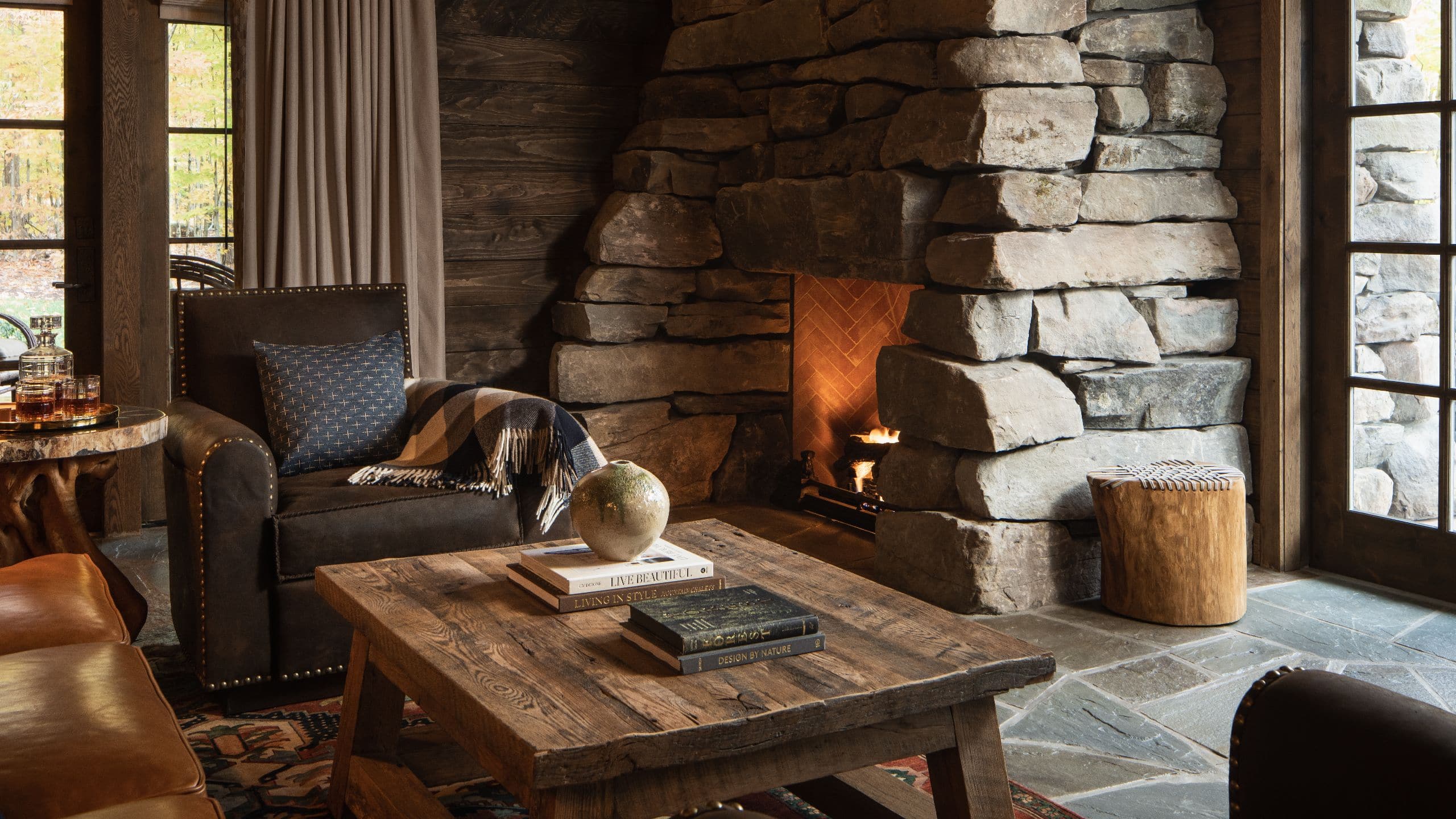 5 of 12 The Chatwal Lodge Stone Cottage Fireplace View