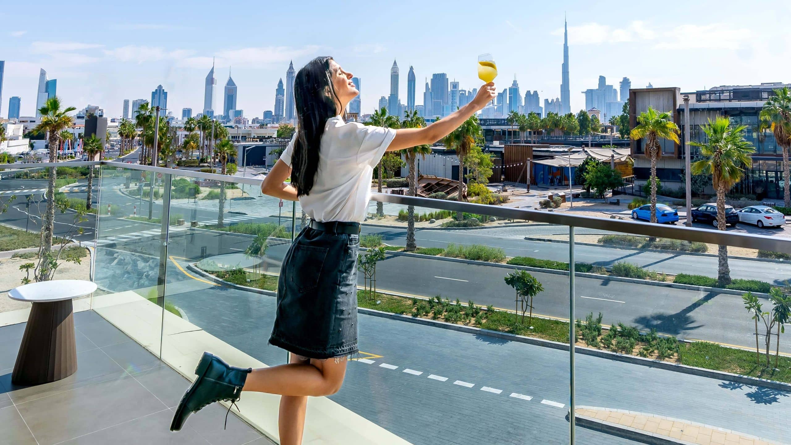 Hyatt Centric Jumeirah Dubai Woman Standing Patio Balcony Holding Glass