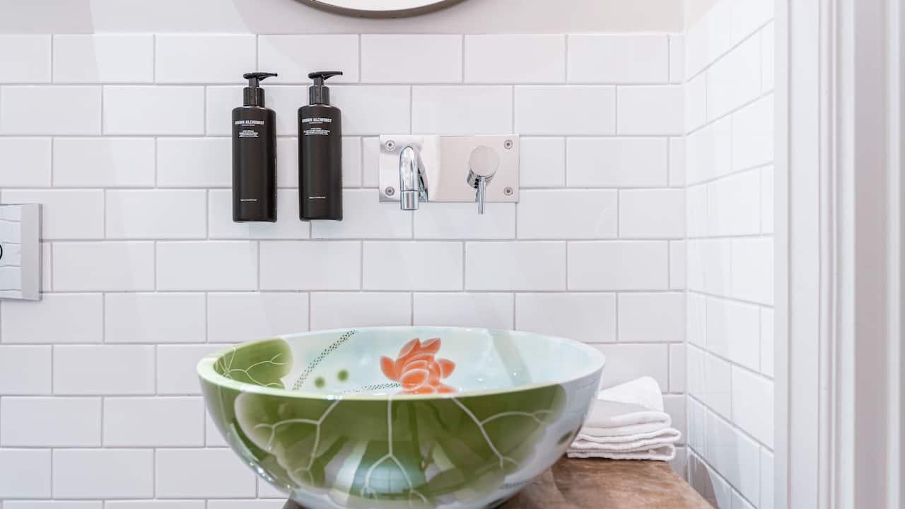 Bathroom products from the brand Grown Alchemist and a beautiful designer sink