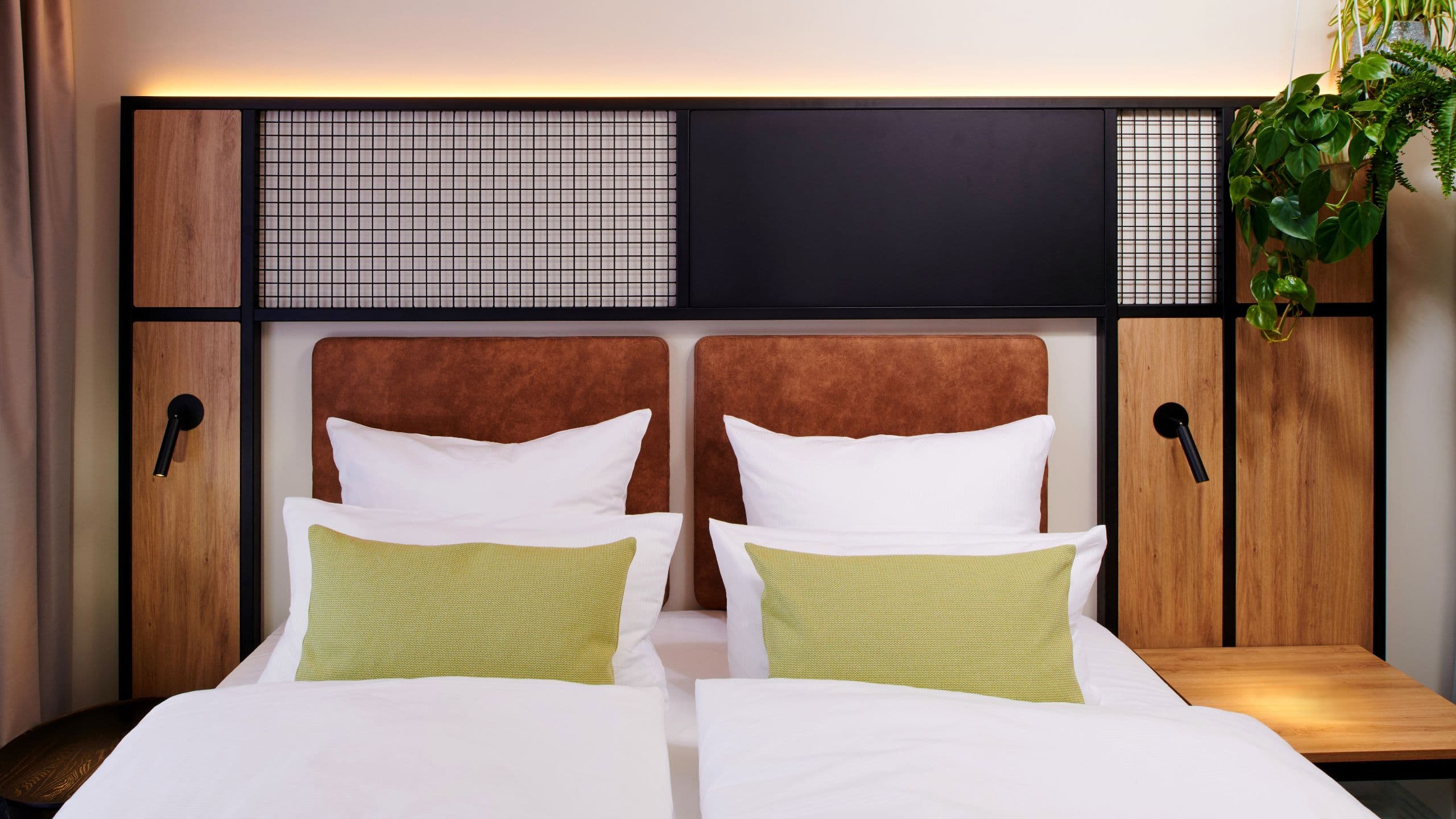 A spacious deluxe room with a comfortable king bed at Me and All Hotel Ulm.