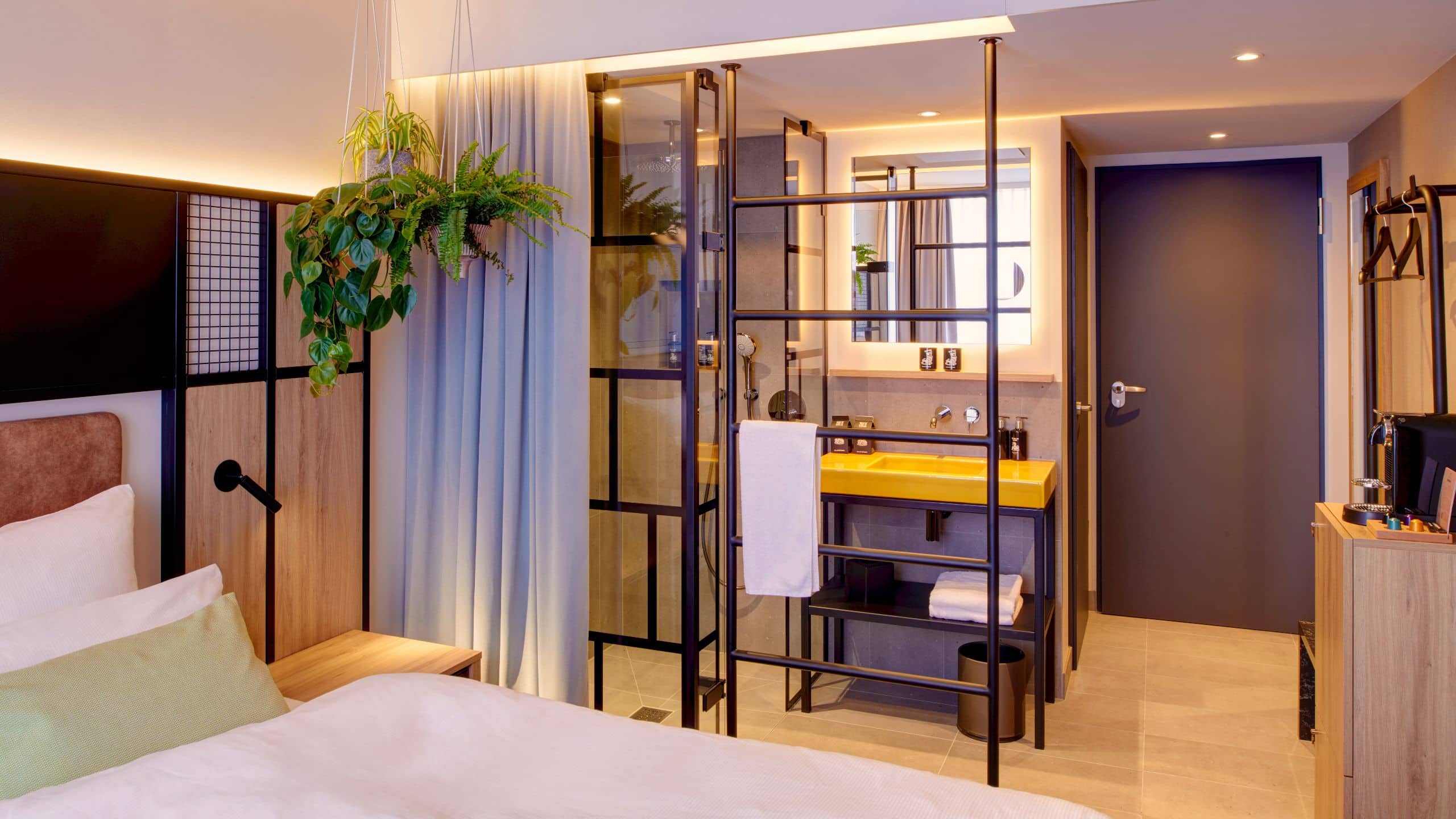 Modernly furnished room with a king-size bed and stylish atmosphere at Me and All Hotel Ulm.