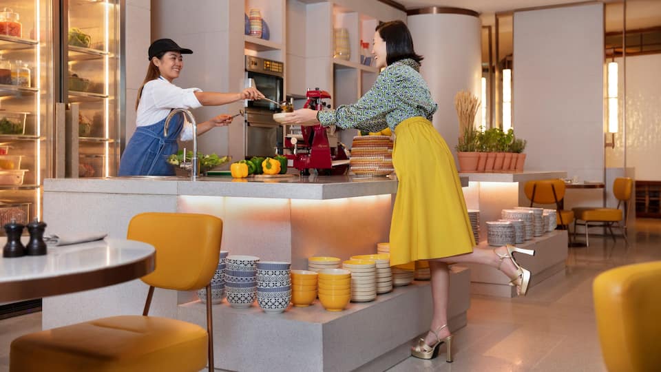 Lady Being Served Food at Singapore Restaurant