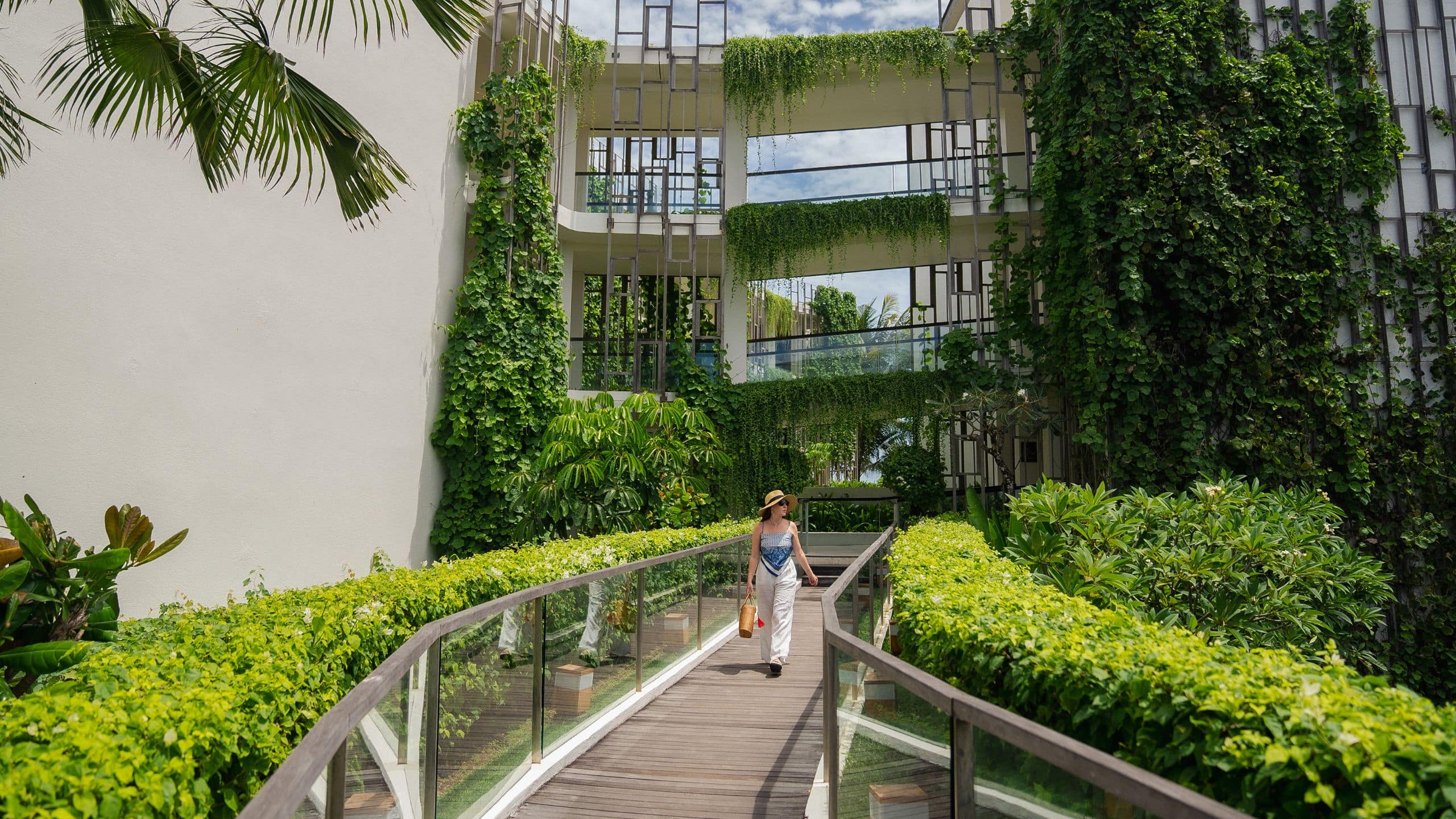 Alila Seminyak Woman At Connecting Bridge