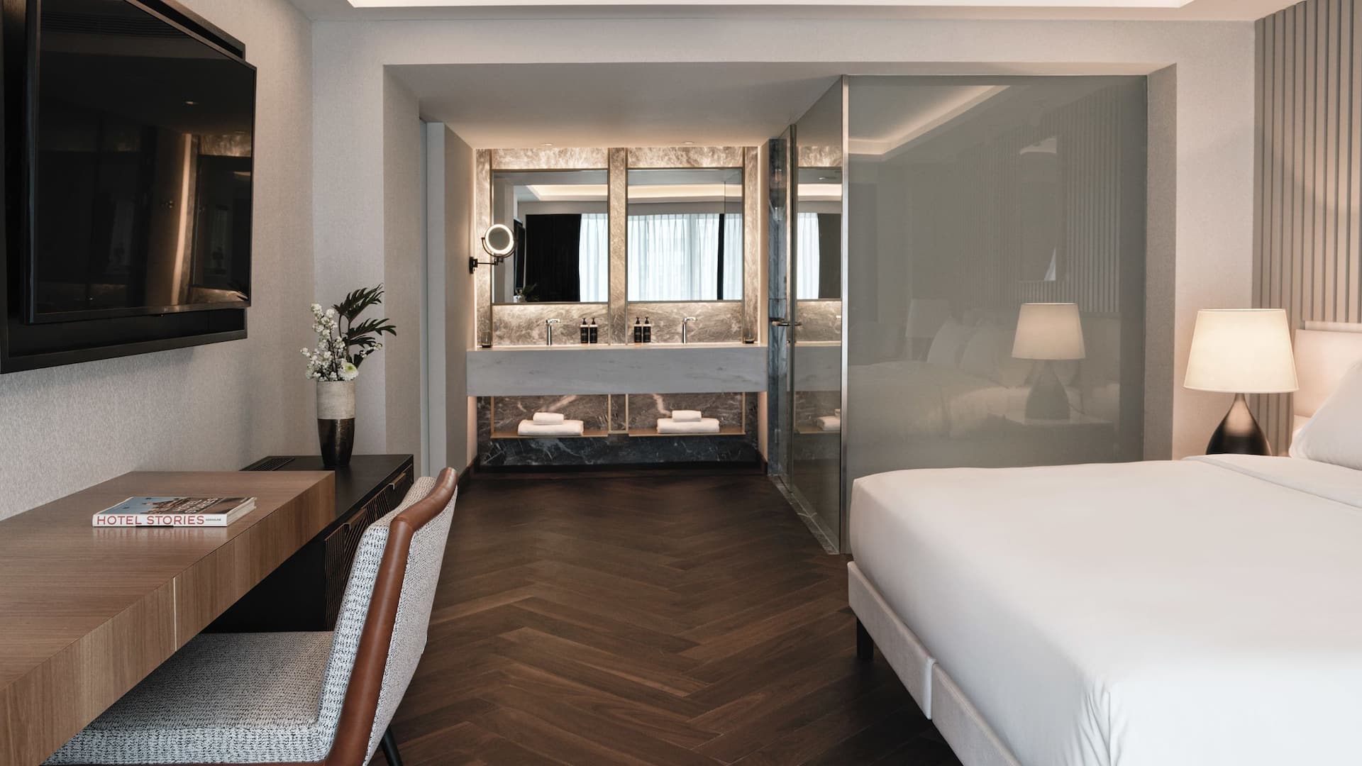 Luxury Grand Suite with sleek lines, hidden lighting, and his & hers sinks at a 5-star hotel near Acropolis in Athens.