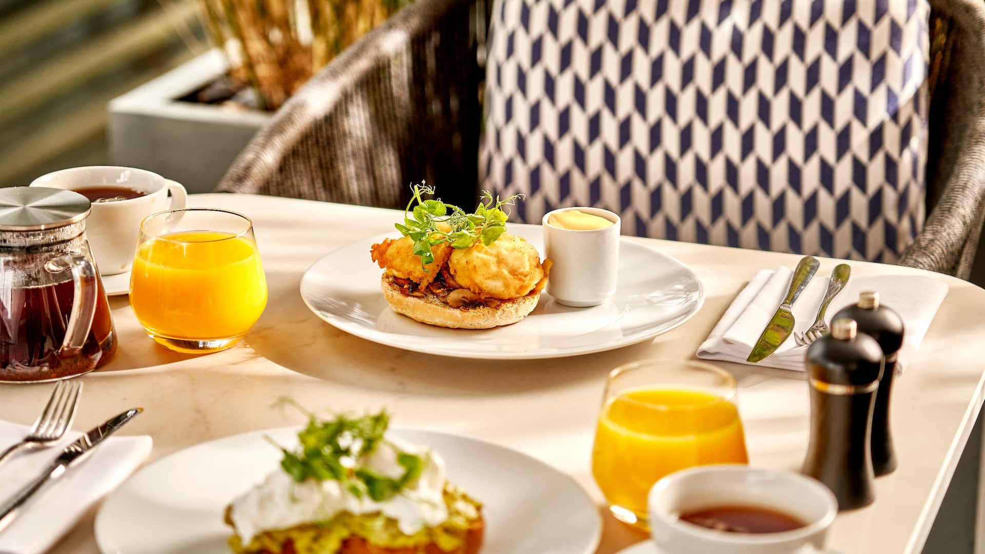 Eggs on toast and orange juice for the breakfast served at Hyatt London Stratford restaurant terrace 