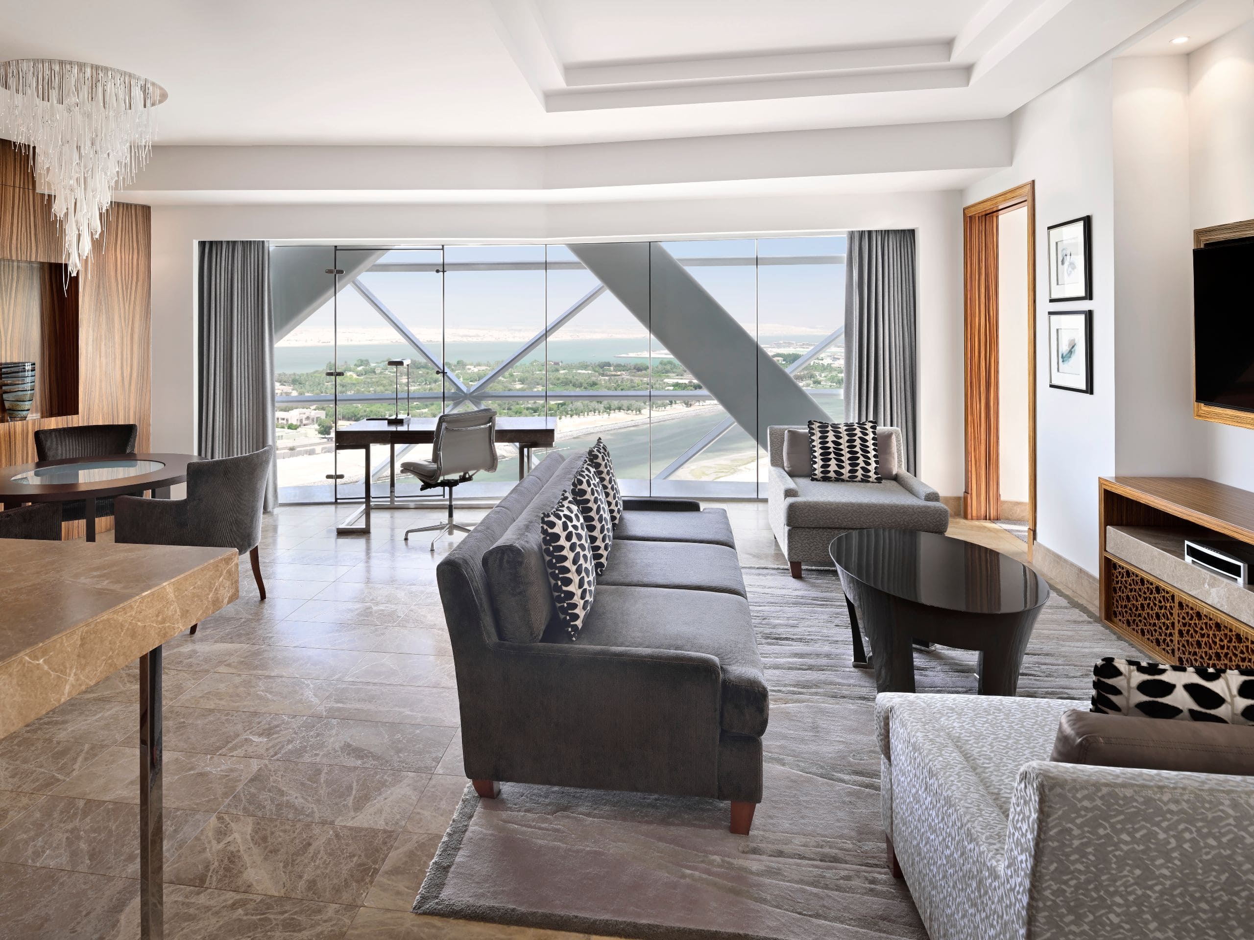 Andaz Capital Gate, Abu Dhabi - Take in sweeping city views from a stylish suite with floor-to-ceiling windows, living space, and spa bath.