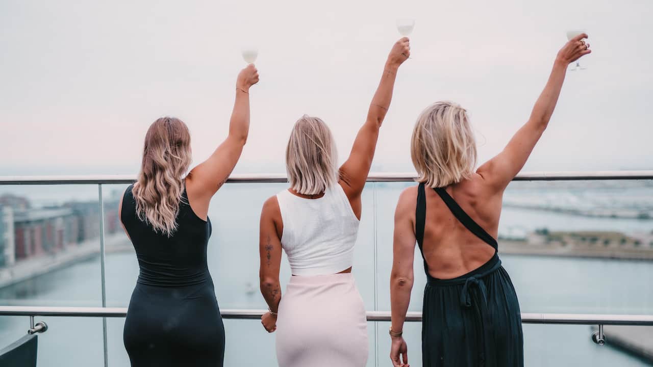Guests at the roof top terrace at Story Hotel Studio Malmö with ocean view in background