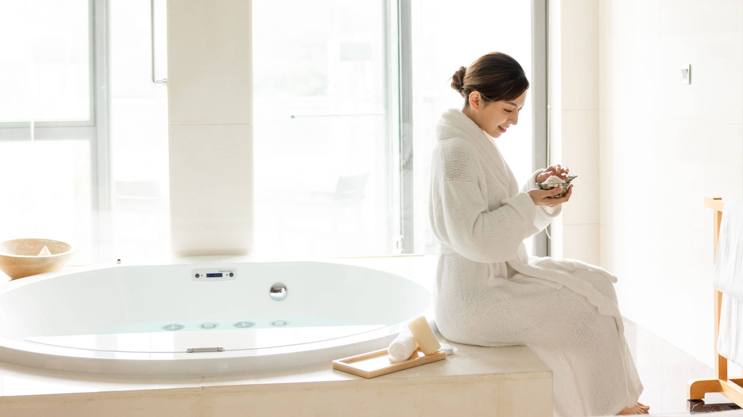 Female Sitting Next To Tub