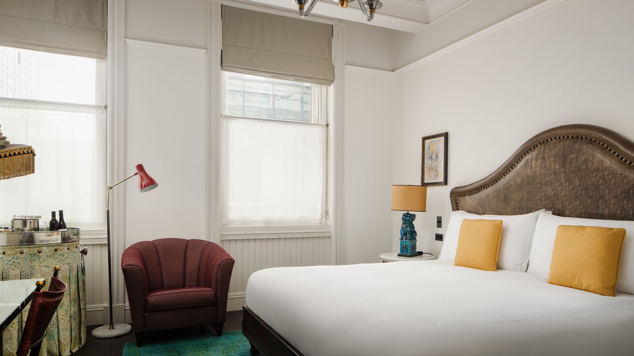 King bed with side chair and two windows