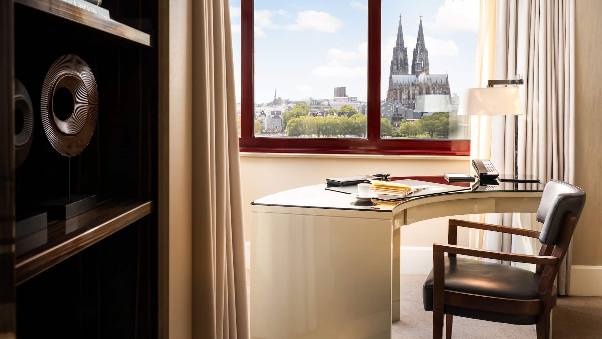 Desk corner in suite of Hyatt Regency Cologne with view of cathedral