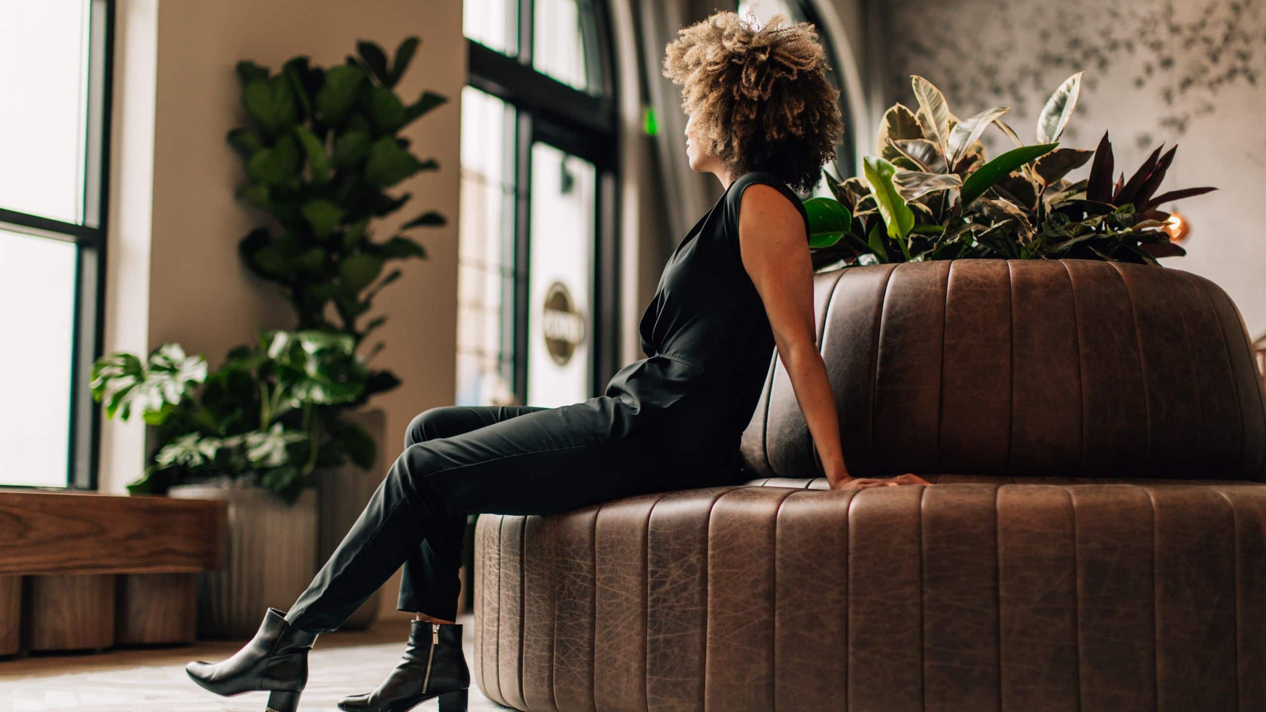 Kissel Uptown Oakland Guest Seated On Lobby Couch