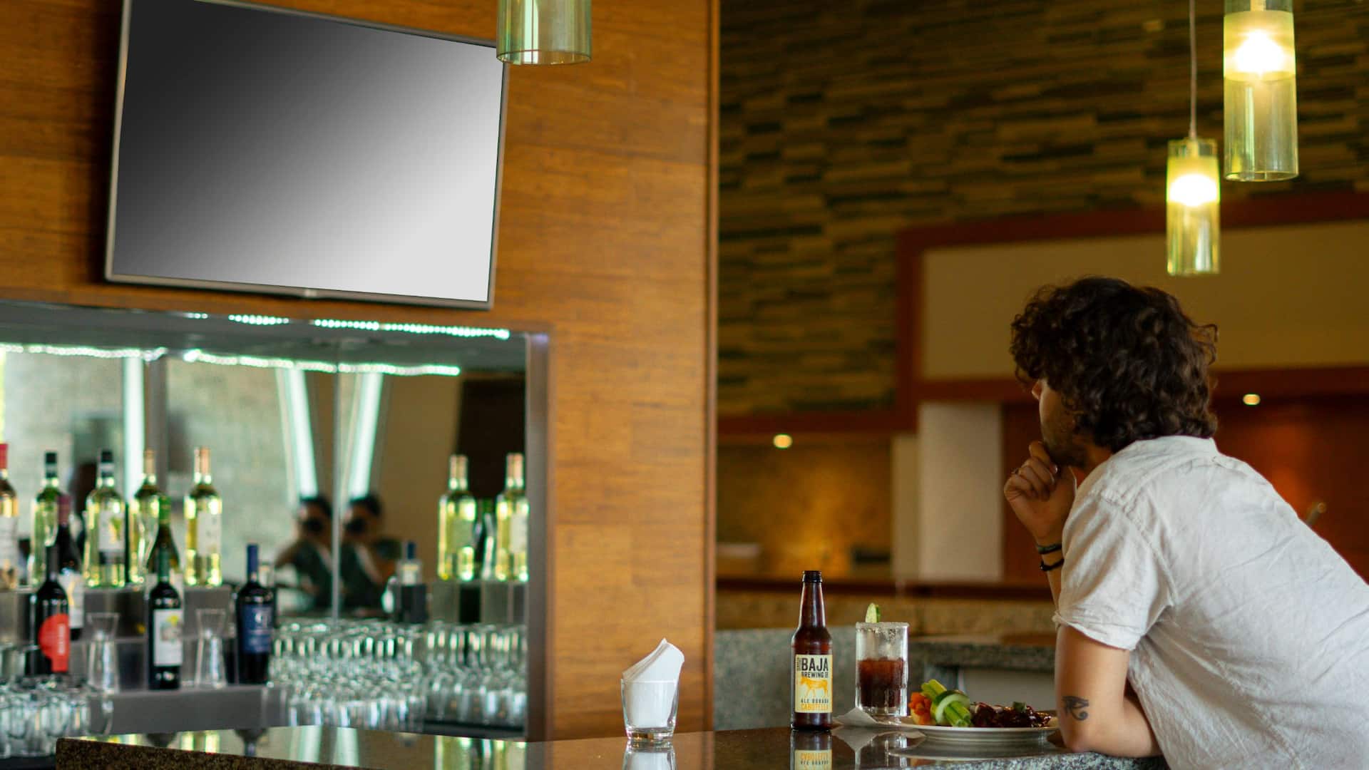 Hyatt Place Los Cabos Guest Watching A Game At The Bar