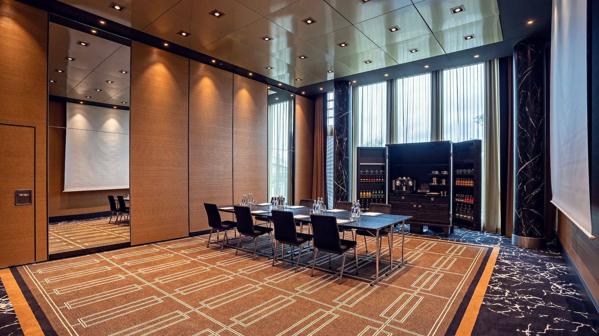 Conference room at Hyatt Regency Dusseldorf, seating, tables, screen, floor to ceiling windows, coffee cabinet, and connectin