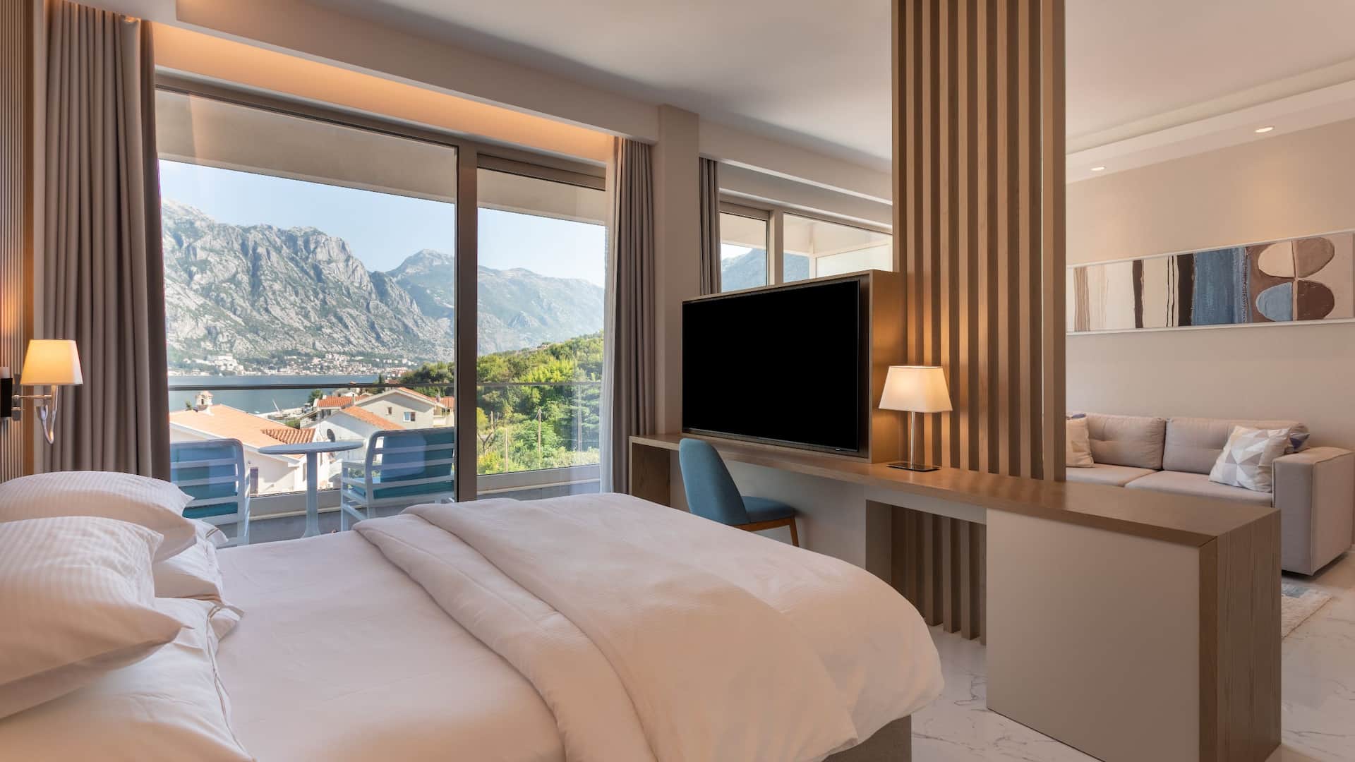 1 de 6 Premium sea-view suite at Hyatt Regency Kotor Bay with a king bed, elegant decor, and a private balcony overlooking the bay and mountains.