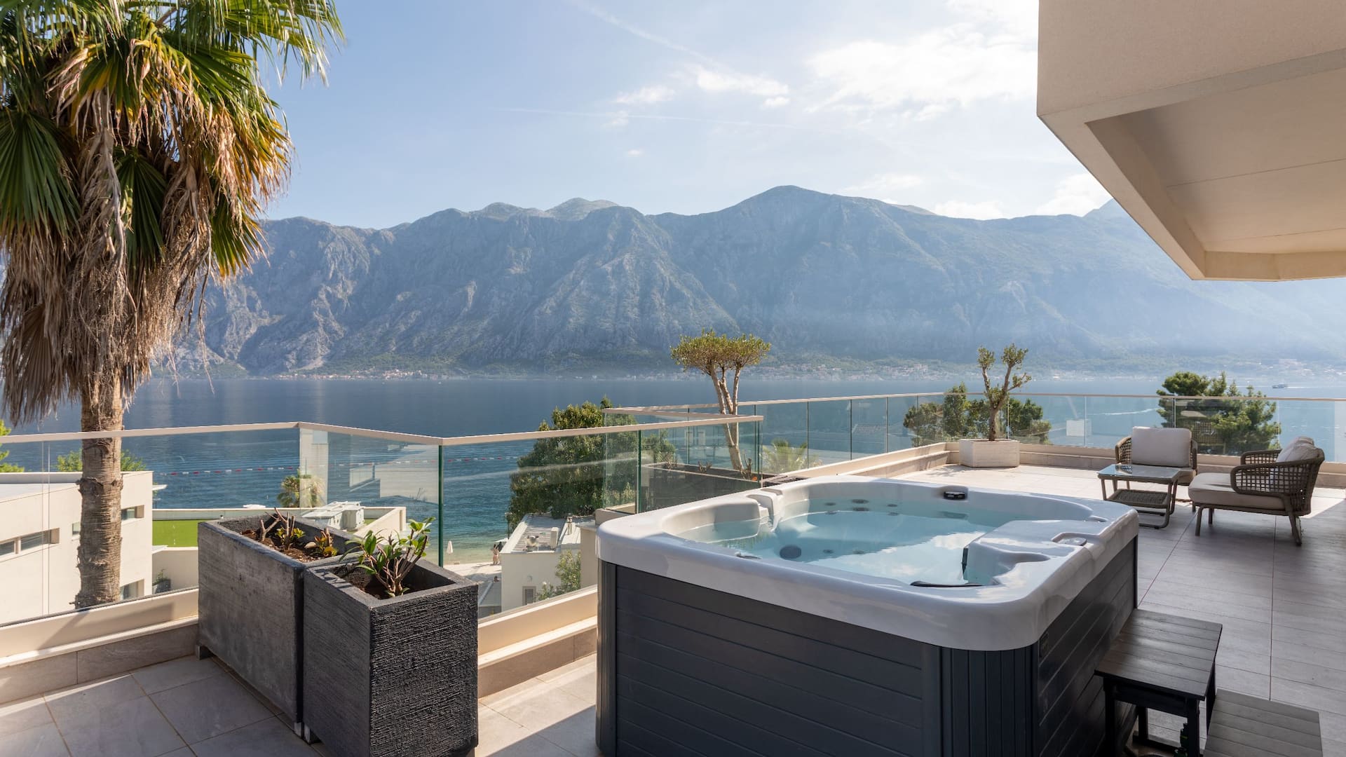 Sea View Suite in Montenegro's Hyatt Regency Kotor Bay Resort with a private hot tub on the balcony, overlooking the stunning bay