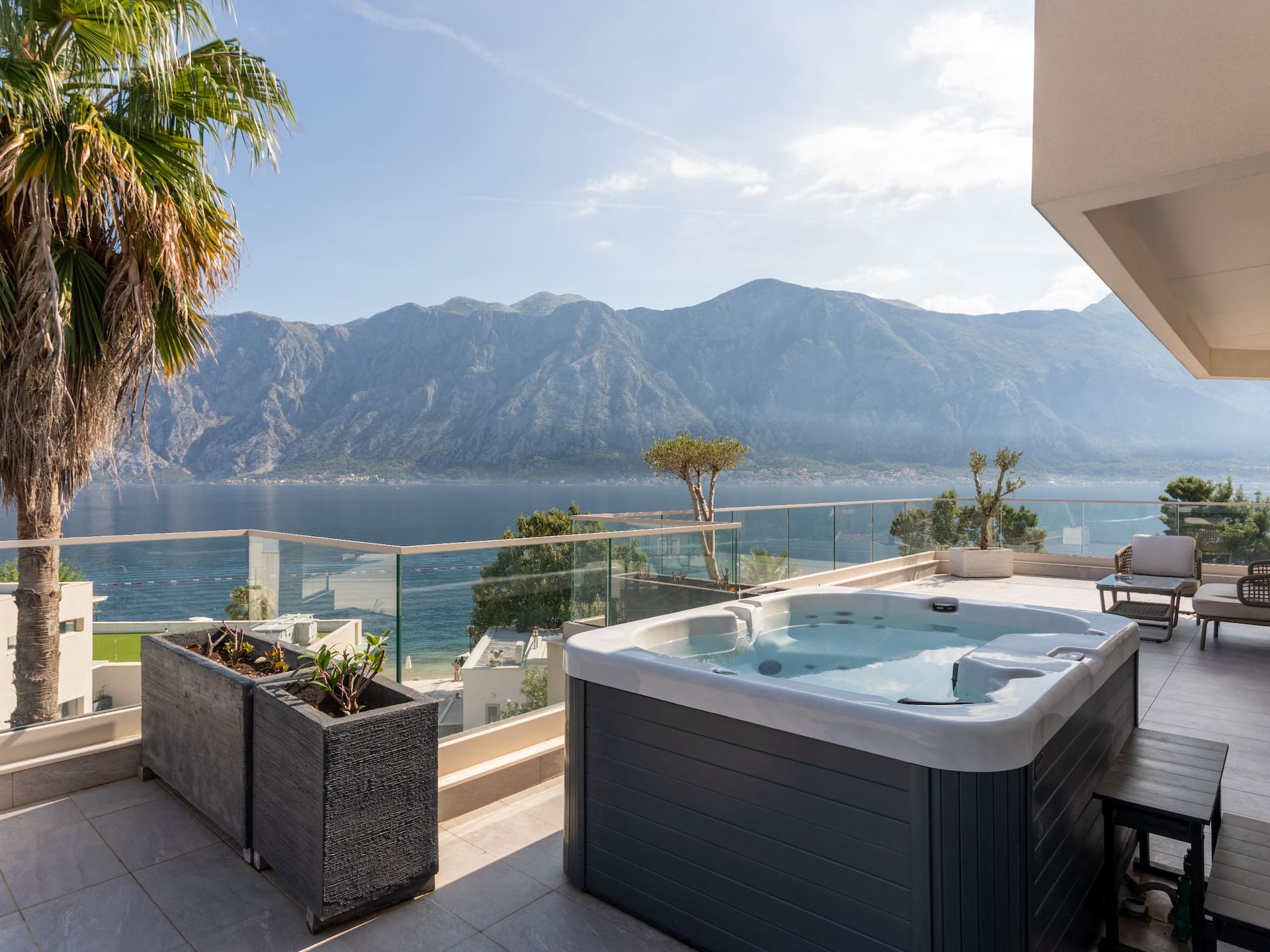 Sea View Suite in Montenegro's Hyatt Regency Kotor Bay Resort with a private hot tub on the balcony, overlooking the stunning bay.