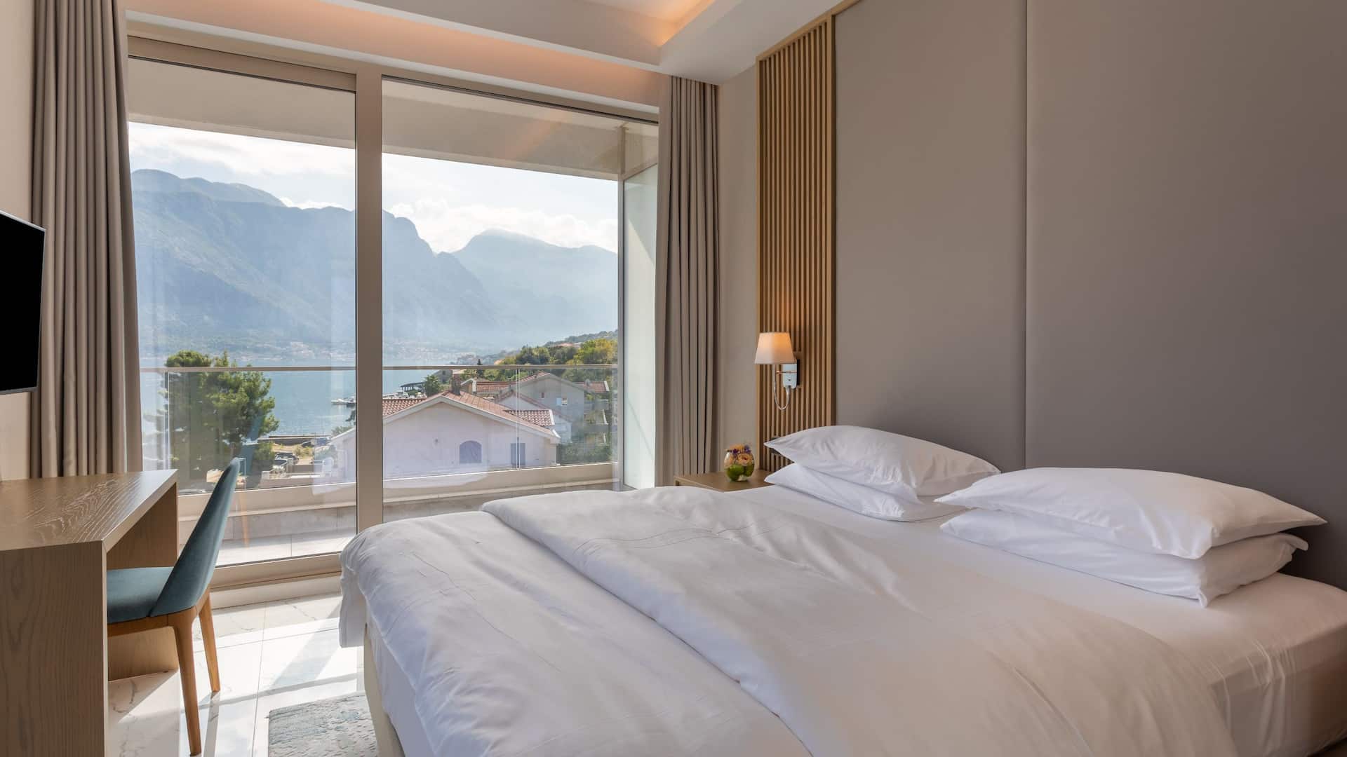Montenegro hotel suite at Hyatt Regency Kotor Bay Resort with a luxurious bedroom, offering comfort and style with a sea view