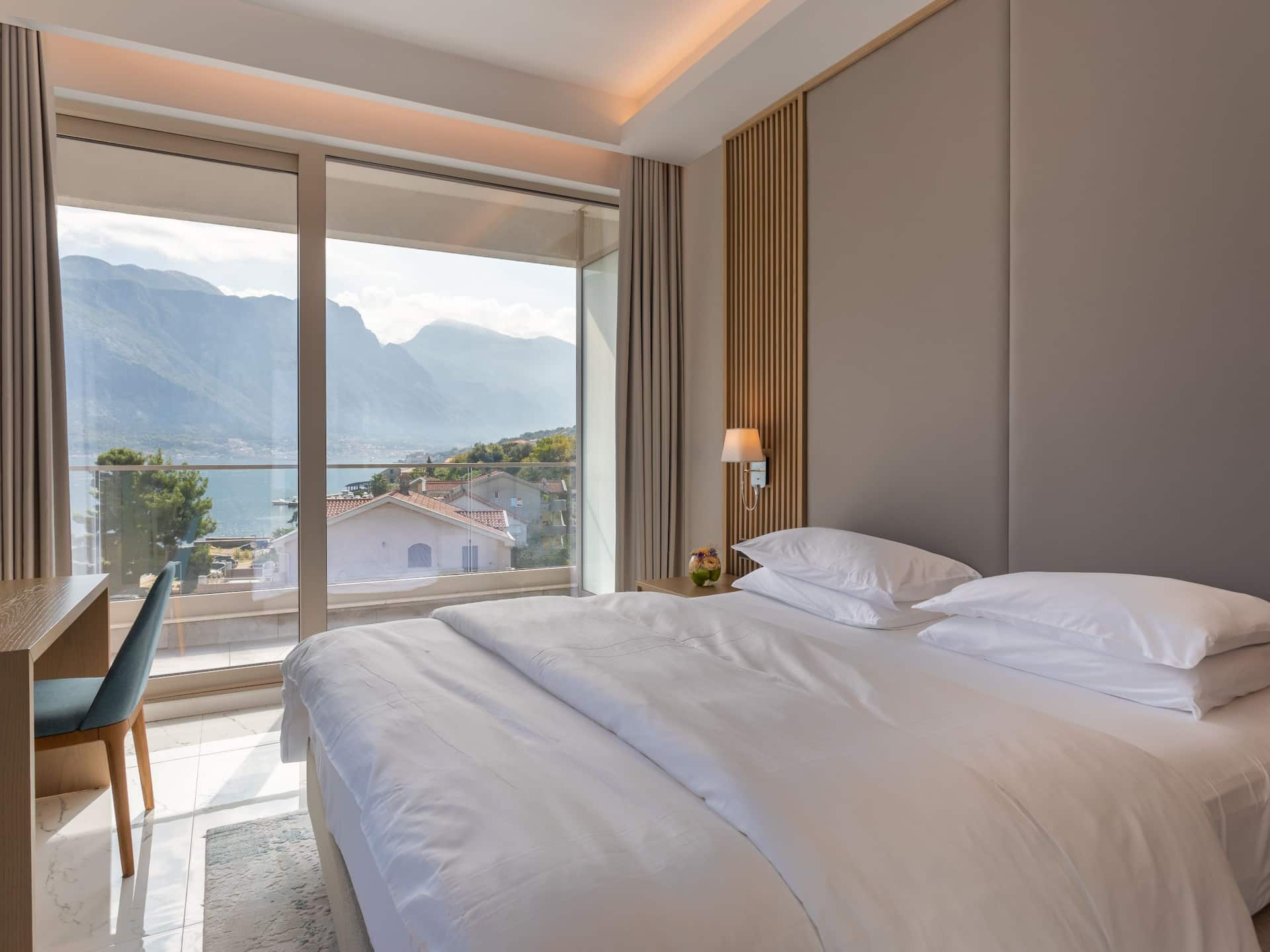 Montenegro hotel suite at Hyatt Regency Kotor Bay Resort with a luxurious bedroom, offering comfort and style with a sea view