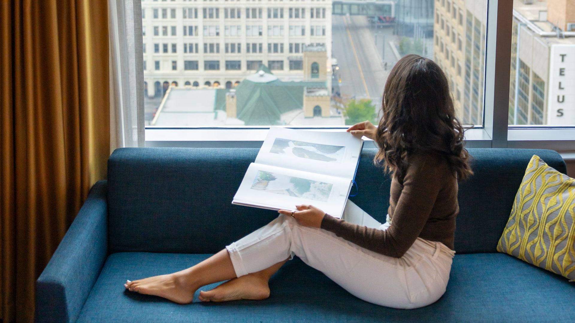 1 of 4 Hyatt Regency Calgary Woman Sitting Guestroom City View