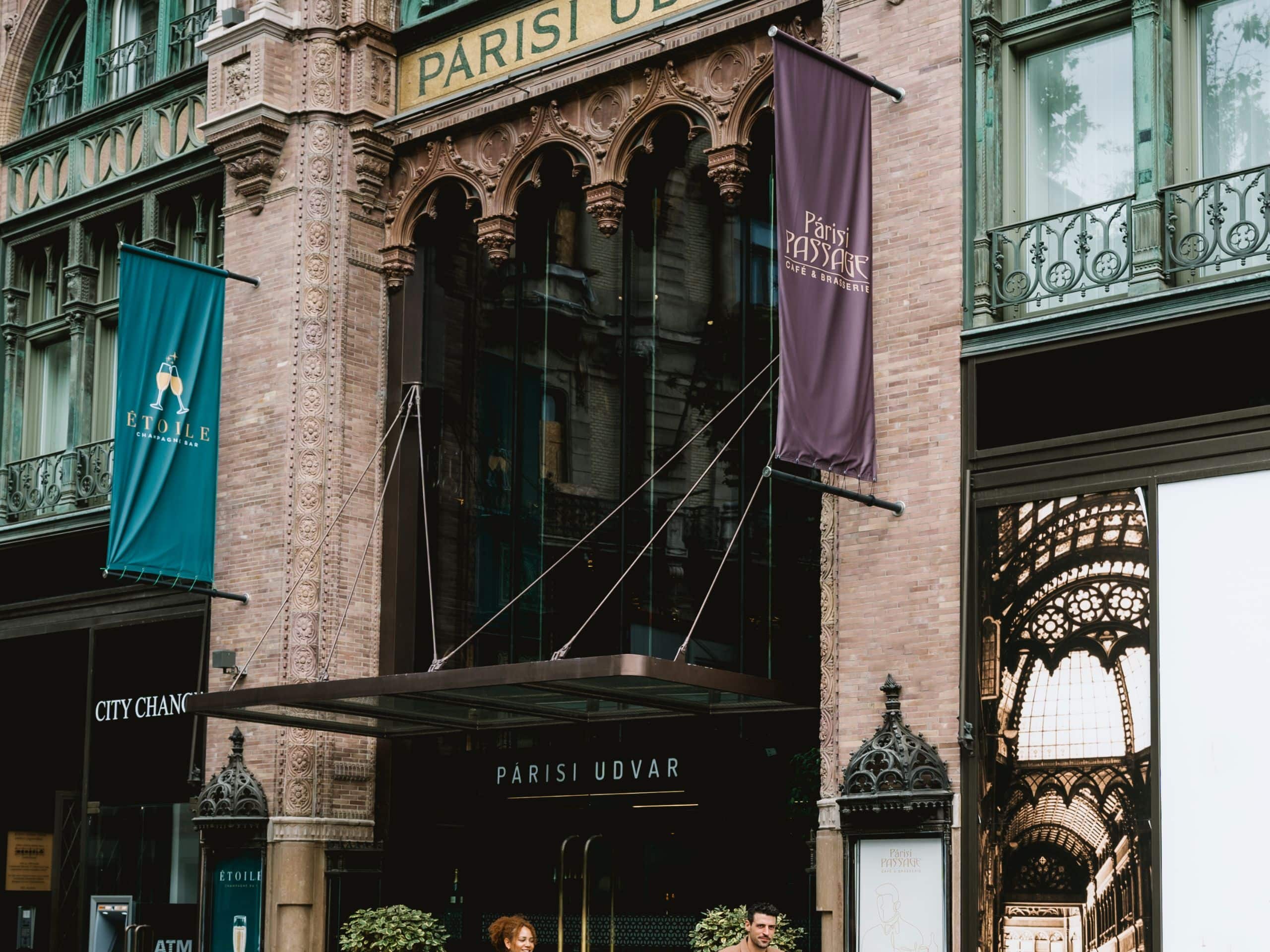 Párisi Udvar Hotel Budapest Couple Cycling In Front Of Parisi Udvar