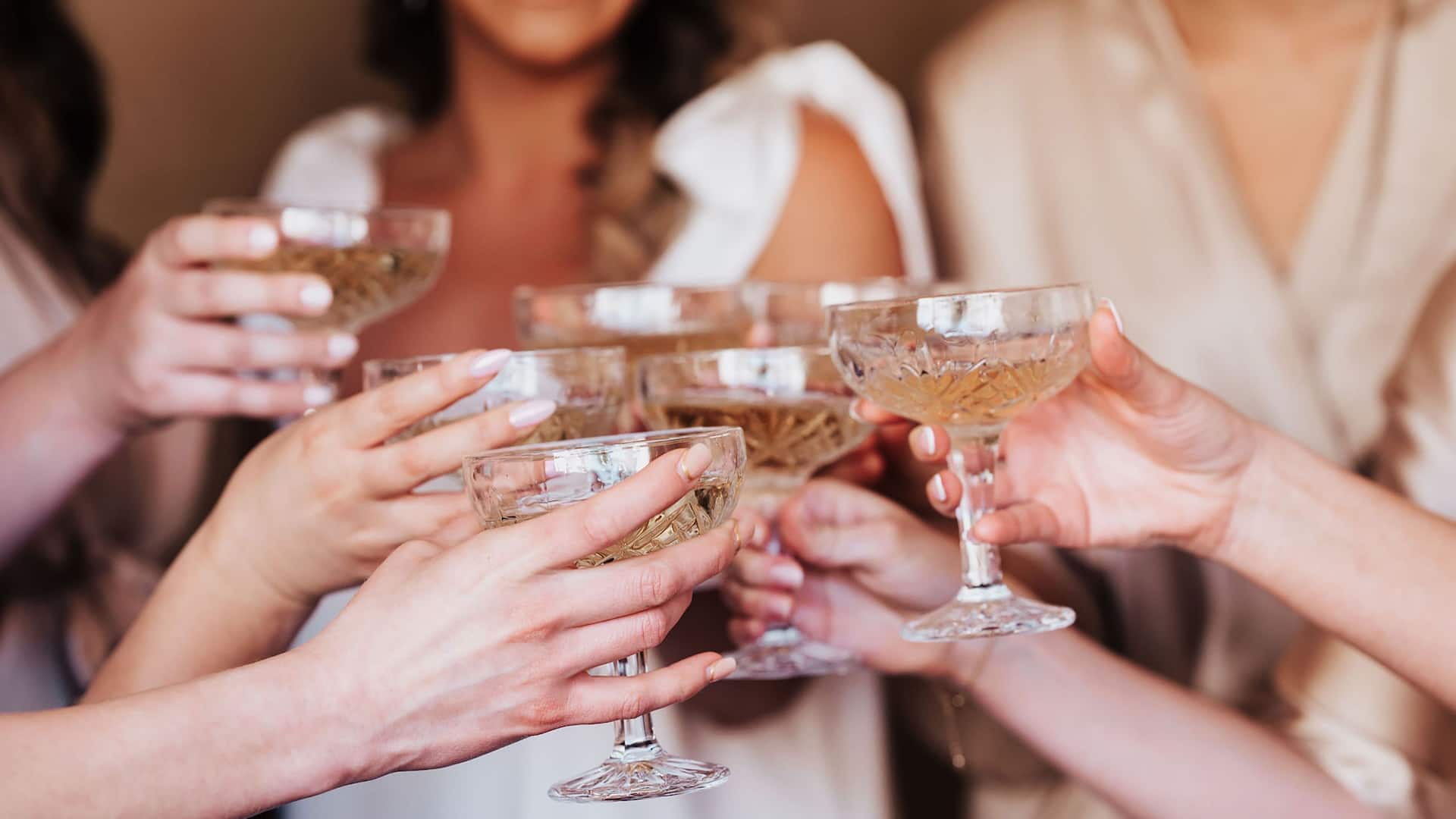 Bridesmaids toast with champagne